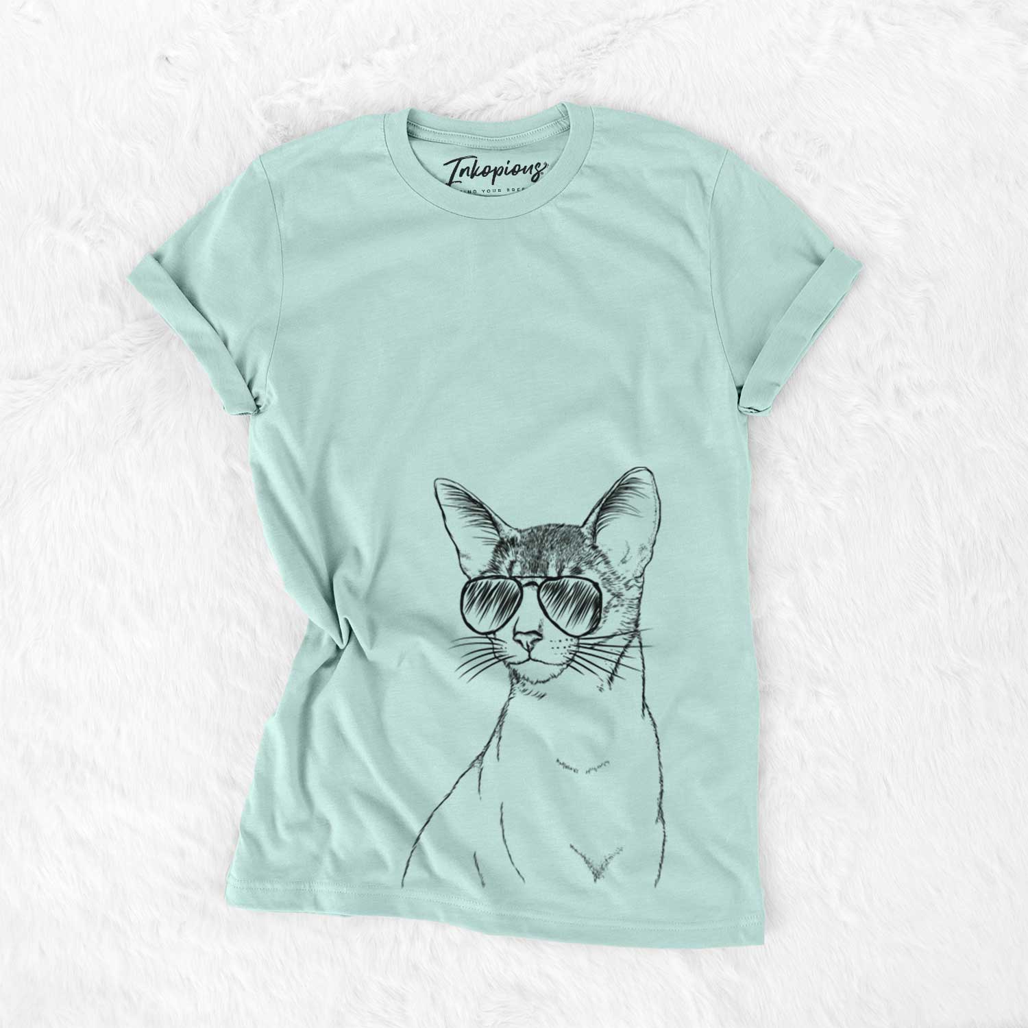 Hand-drawn sketch of Cedric the Abyssinian Cat wearing aviator sunglasses on a Heather Sage Unisex crewneck