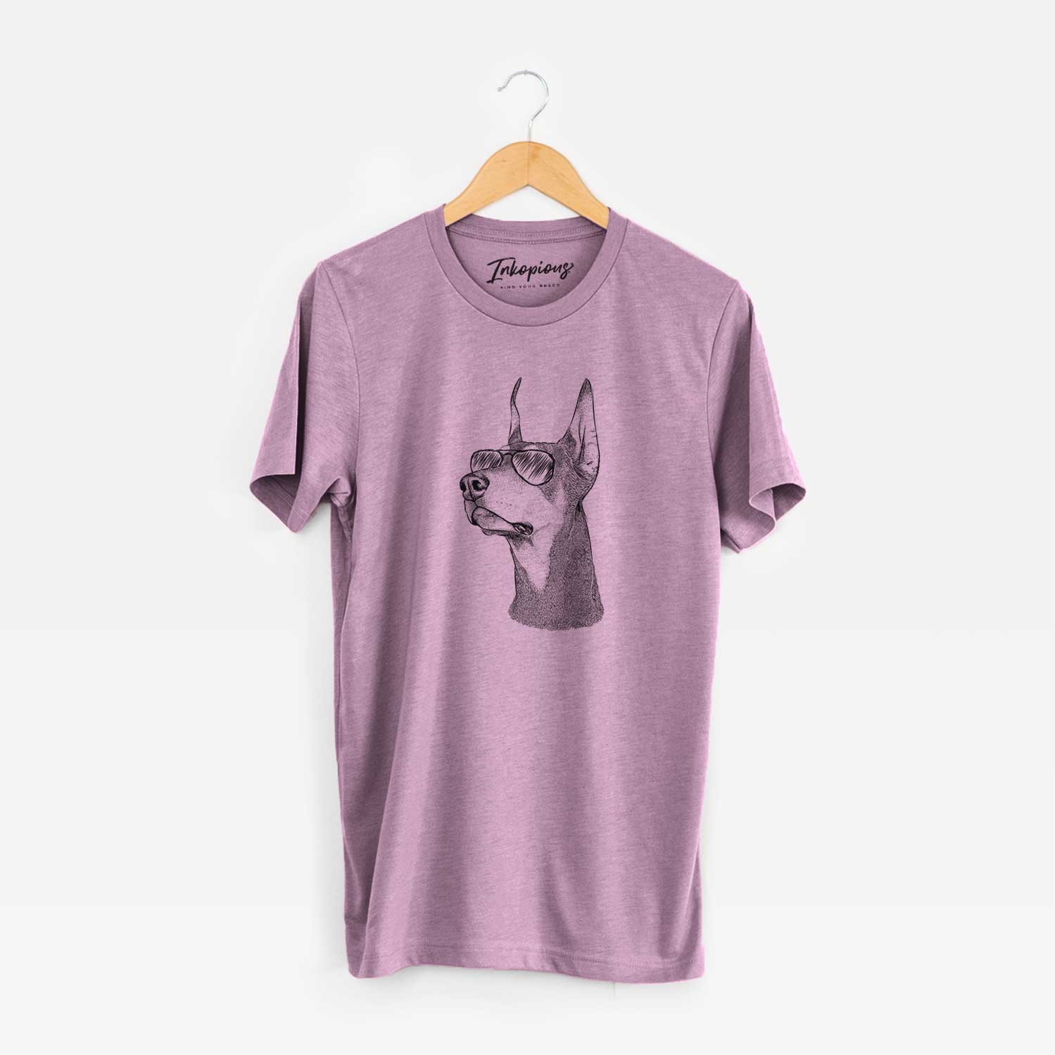Hand-drawn sketch of Cenza the Doberman Pinscher wearing aviator sunglasses on an Orchid Unisex crewneck