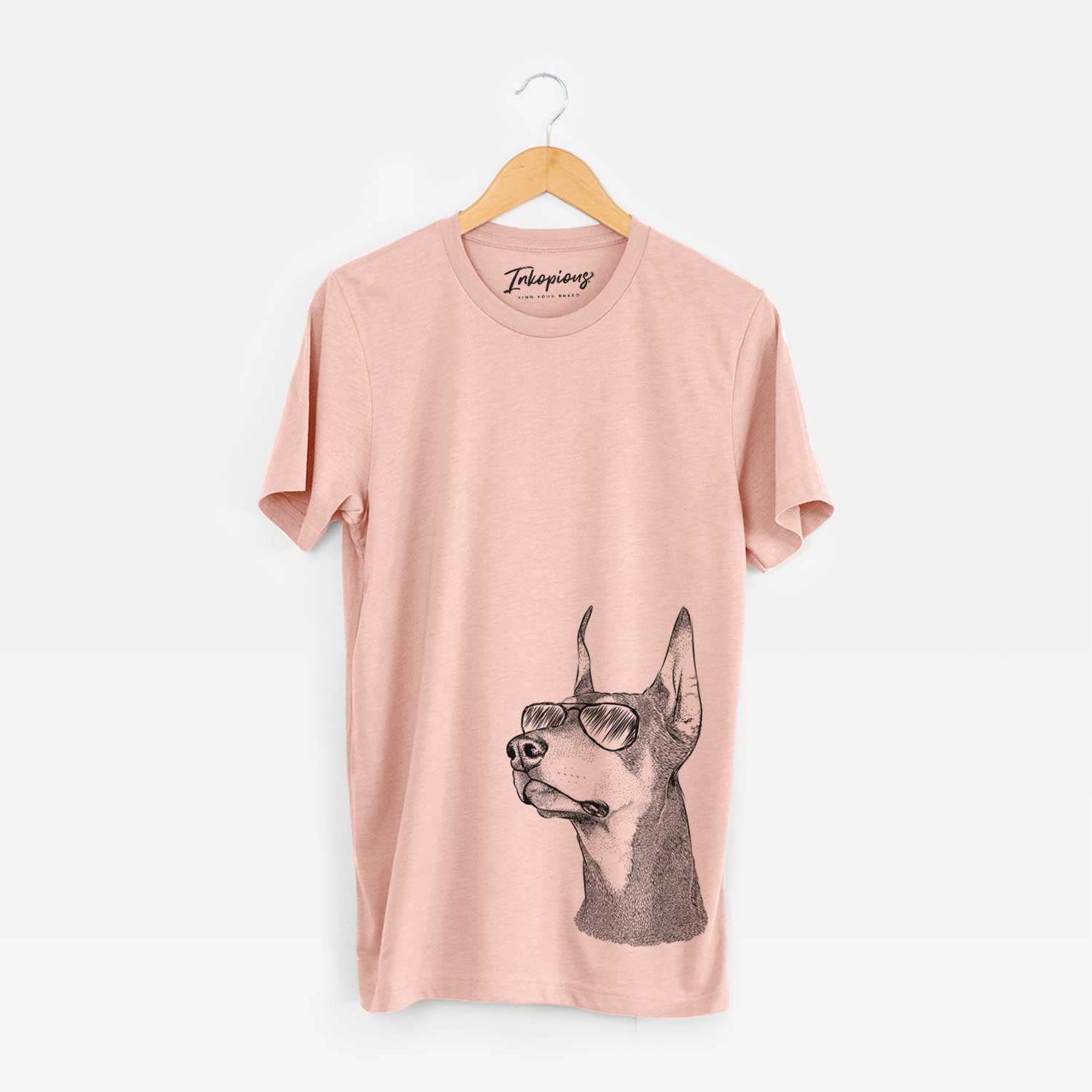 Hand-drawn sketch of Cenza the Doberman Pinscher wearing aviator sunglasses on a Peach Unisex crewneck