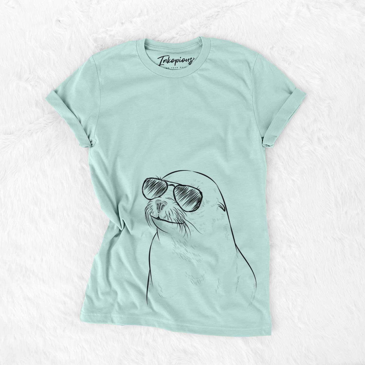 Hand-drawn sketch of Chip the California Sea Lion wearing aviator sunglasses on a Heather Sage Unisex crewneck