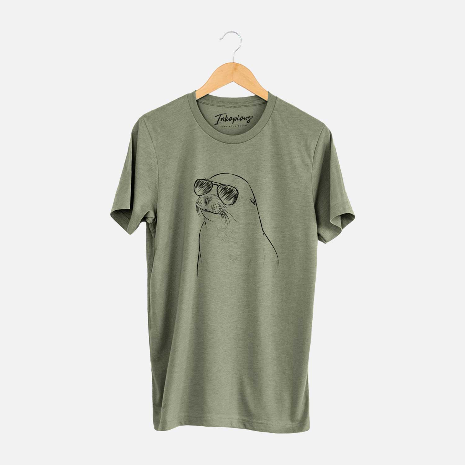 Hand-drawn sketch of Chip the California Sea Lion wearing aviator sunglasses on an Olive Unisex crewneck