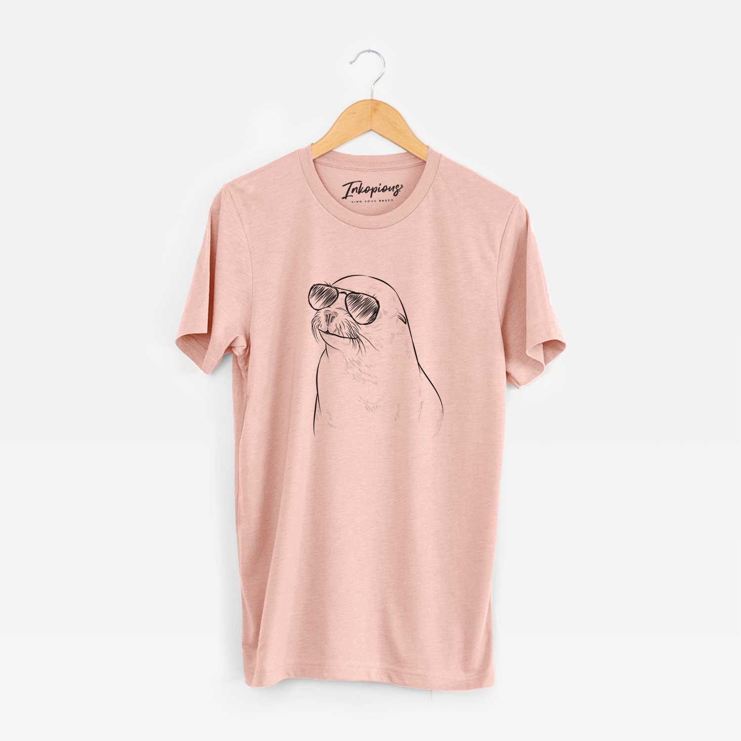 Hand-drawn sketch of Chip the California Sea Lion wearing aviator sunglasses on a Peach Unisex crewneck