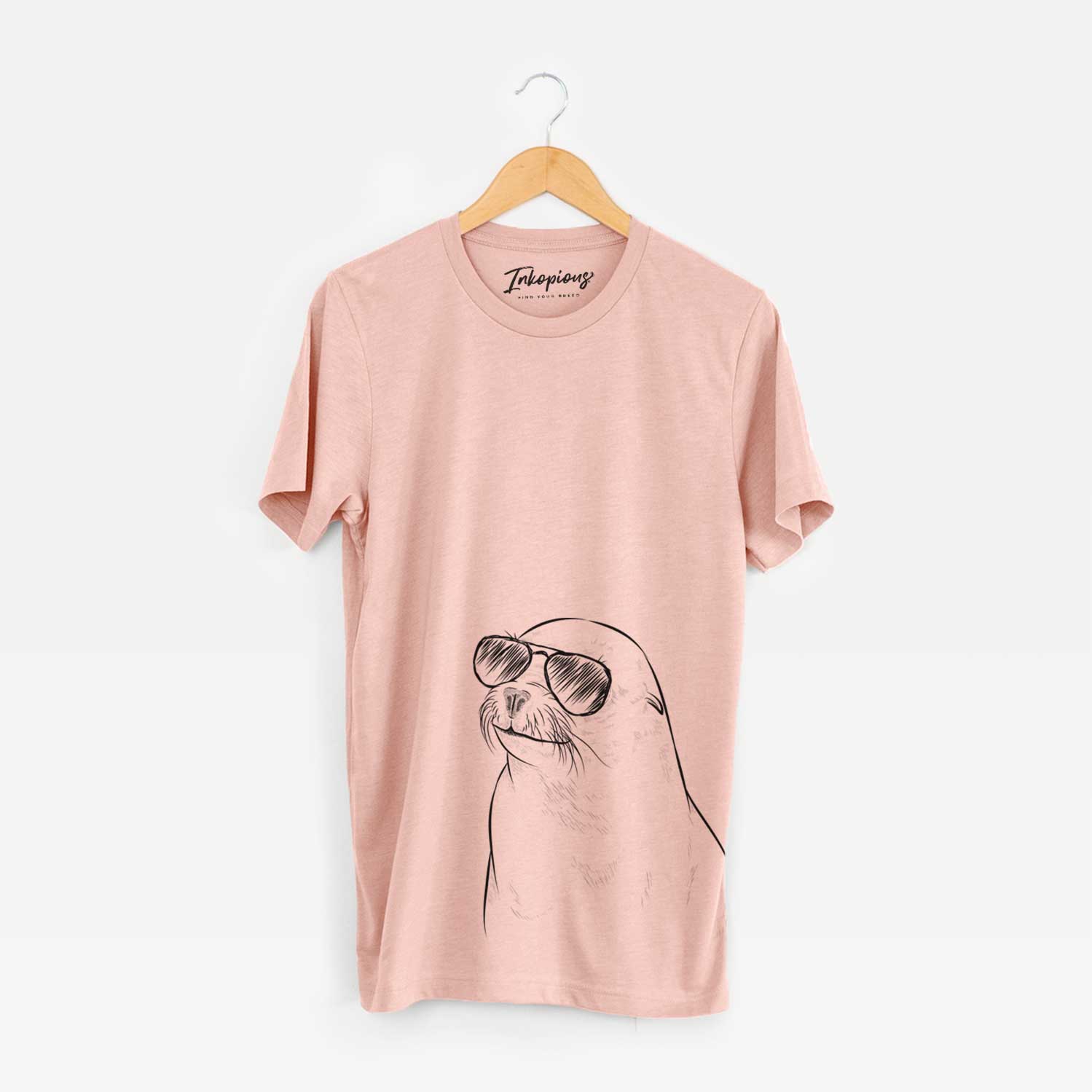 Hand-drawn sketch of Chip the California Sea Lion wearing aviator sunglasses on a Peach Unisex crewneck