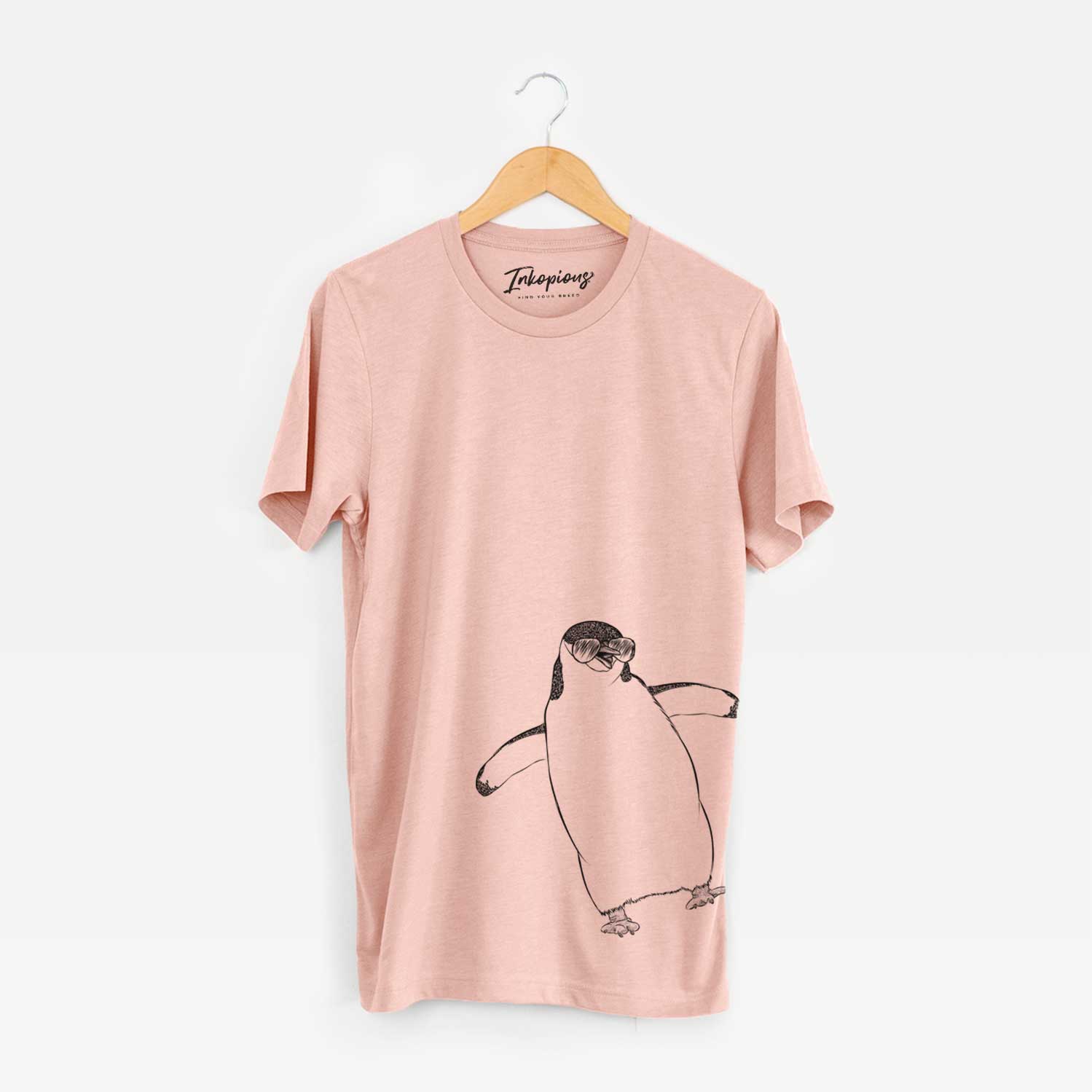 Hand-drawn sketch of Chive the Chinstrap Penguin wearing aviator sunglasses on a Peach Bella Canvas Unisex Crewneck