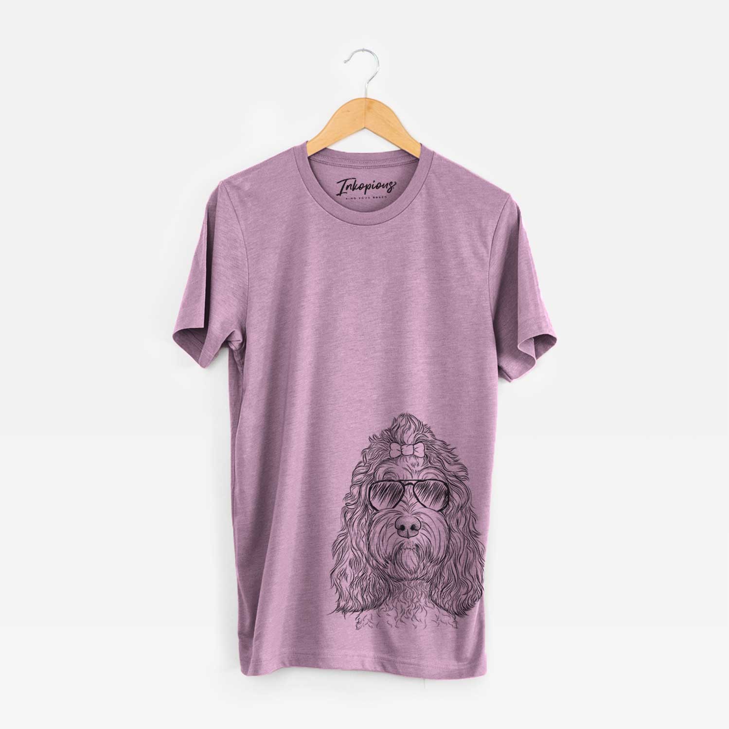 Hand-drawn sketch of Chloe the Cockapoo wearing aviator sunglasses on an Orchid Unisex crewneck