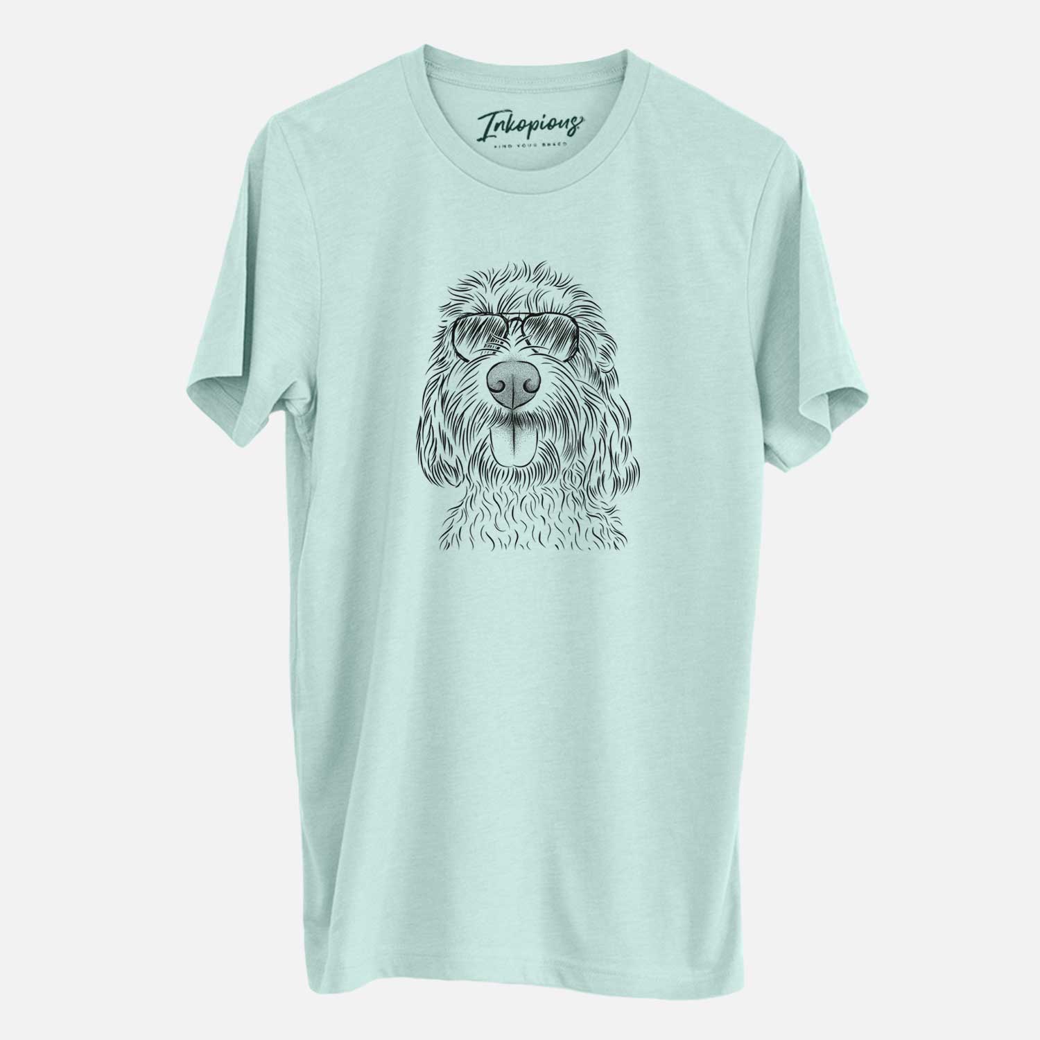 Hand-drawn sketch of Clover the Cockapoo wearing aviator sunglasses on a Heather Sage Unisex crewneck
