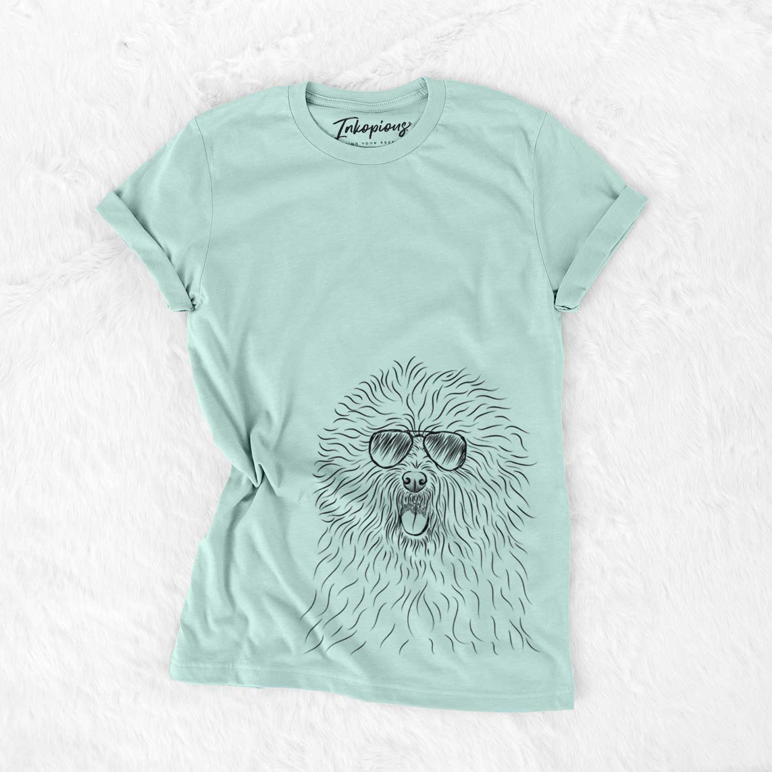 Hand-drawn sketch of Cozie the Old English Sheepdog wearing aviator sunglasses on a Heather Sage Unisex crewneck