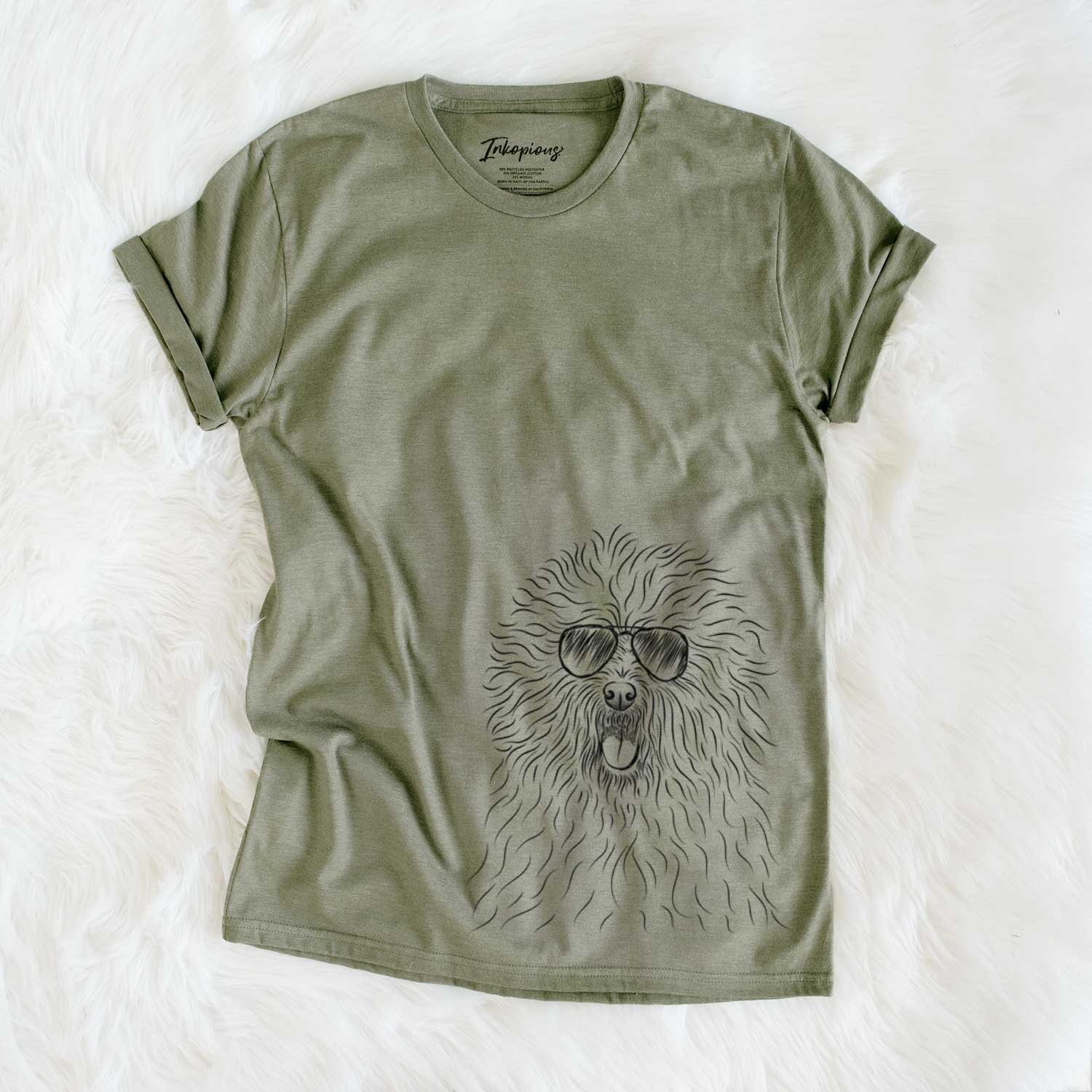 Hand-drawn sketch of Cozie the Old English Sheepdog wearing aviator sunglasses on an Olive Unisex crewneck