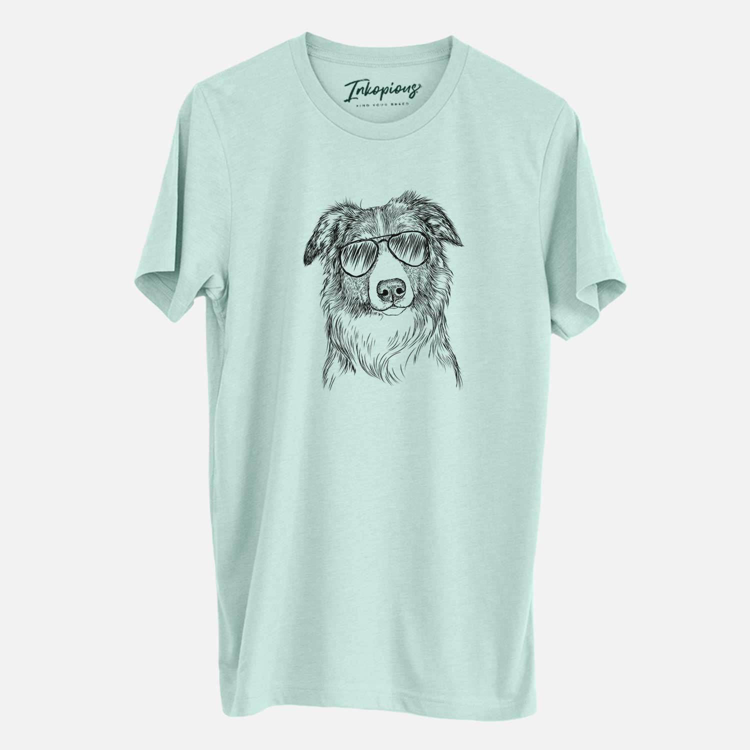 Hand-drawn sketch of Cynder the English Shepherd wearing aviator sunglasses on a Heather Sage Unisex crewneck