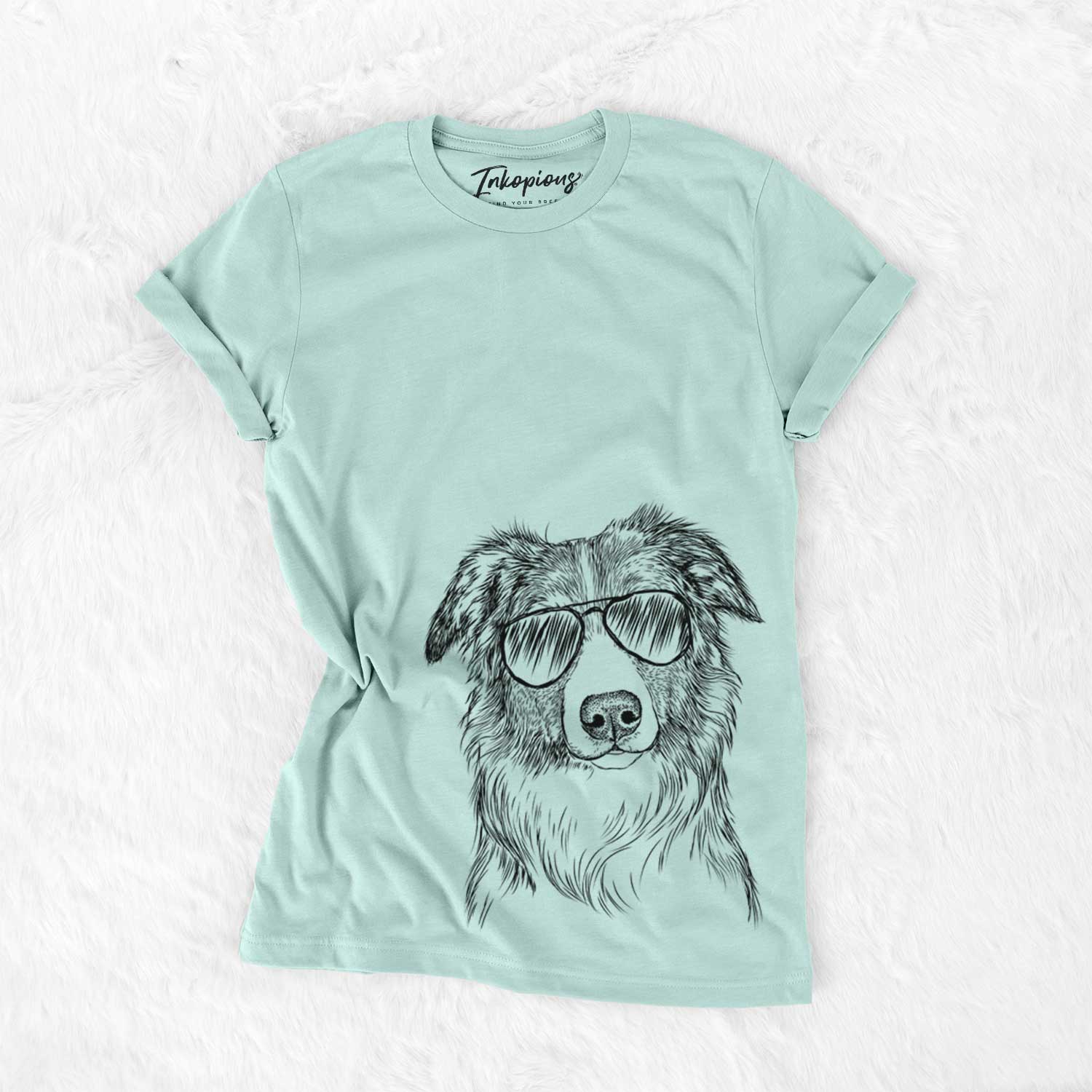 Hand-drawn sketch of Cynder the English Shepherd wearing aviator sunglasses on a Heather Sage Unisex crewneck
