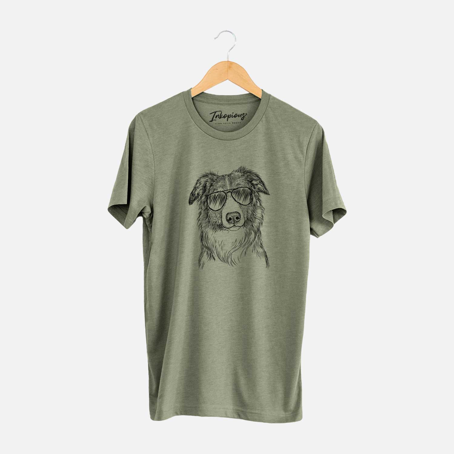 Hand-drawn sketch of Cynder the English Shepherd wearing aviator sunglasses on an Olive Unisex crewneck