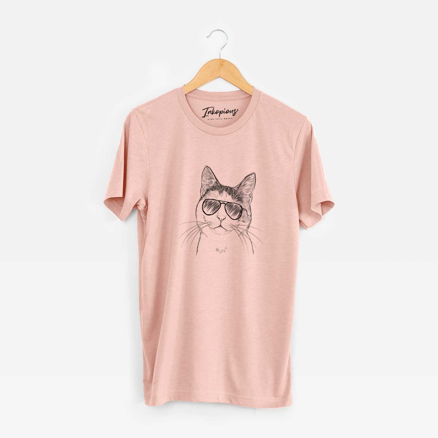 Hand-drawn sketch of Denver the Calico Cat wearing aviator sunglasses on a Peach Unisex crewneck