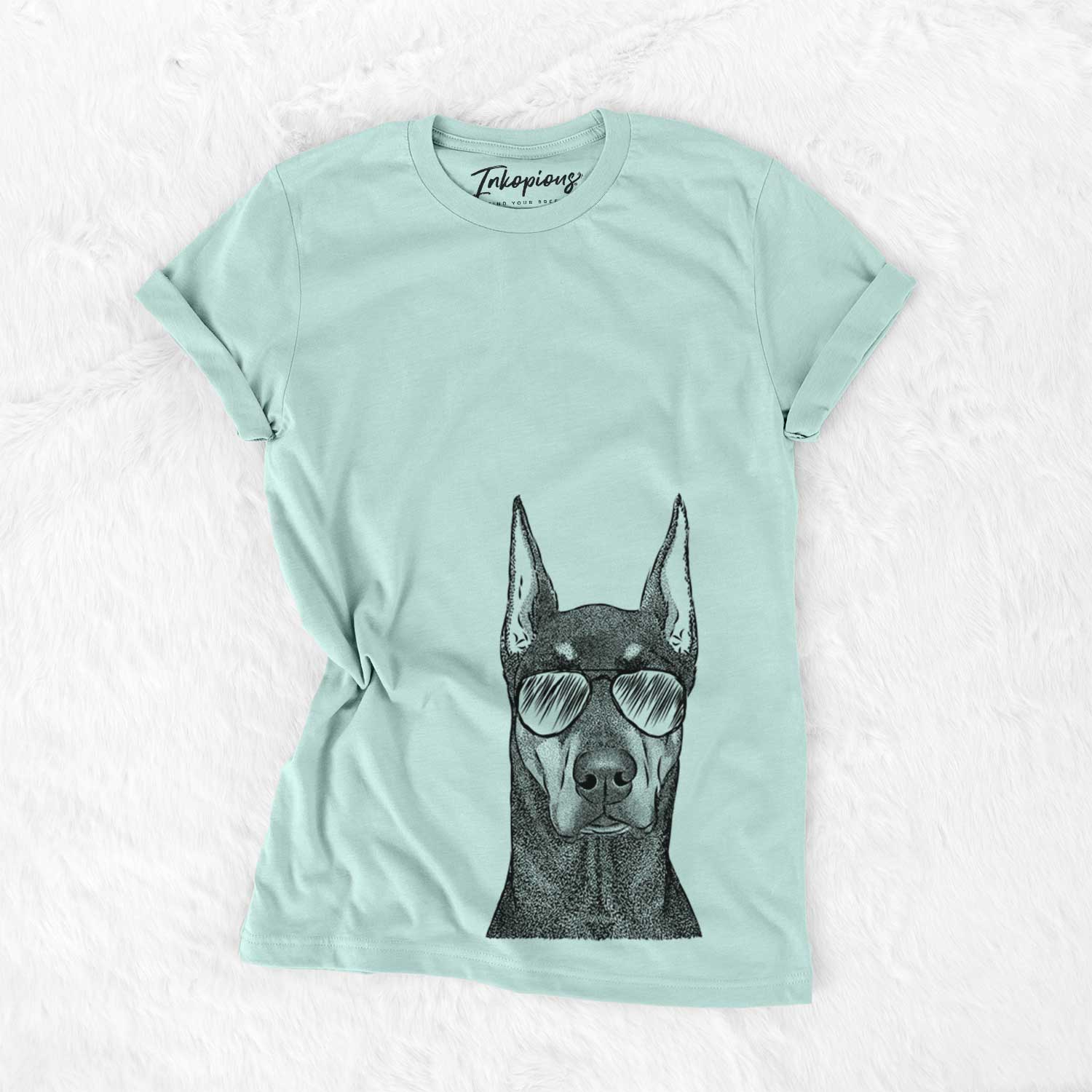 Hand-drawn sketch of Drake the Doberman Pinscher wearing aviator sunglasses on a Heather Sage Unisex crewneck