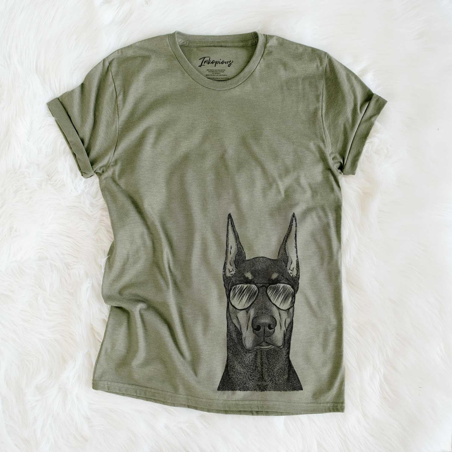 Hand-drawn sketch of Drake the Doberman Pinscher wearing aviator sunglasses on an Olive Unisex crewneck
