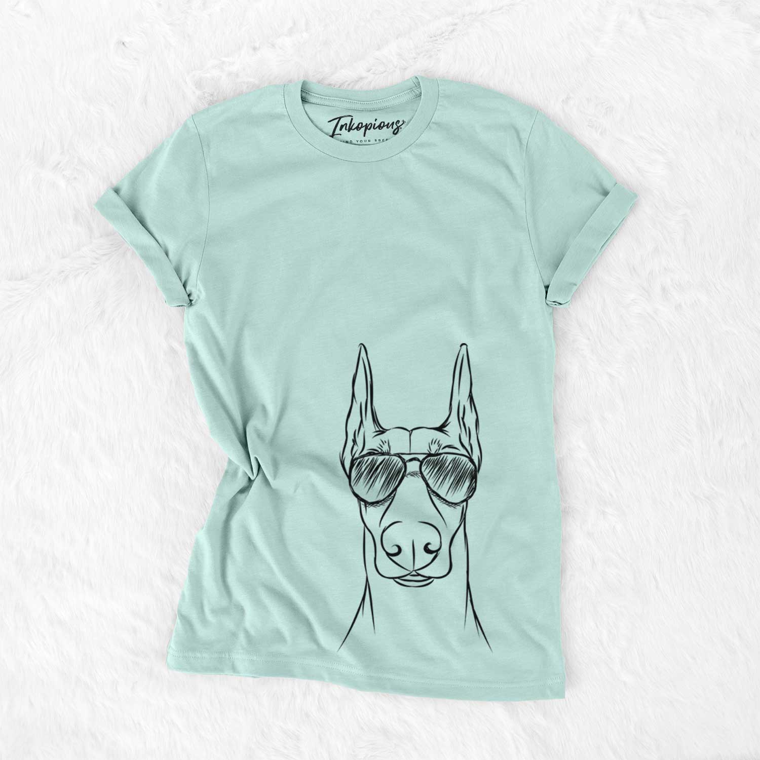 Hand-drawn sketch of Duke the Doberman Pinscher wearing aviator sunglasses on a Heather Sage Unisex crewneck