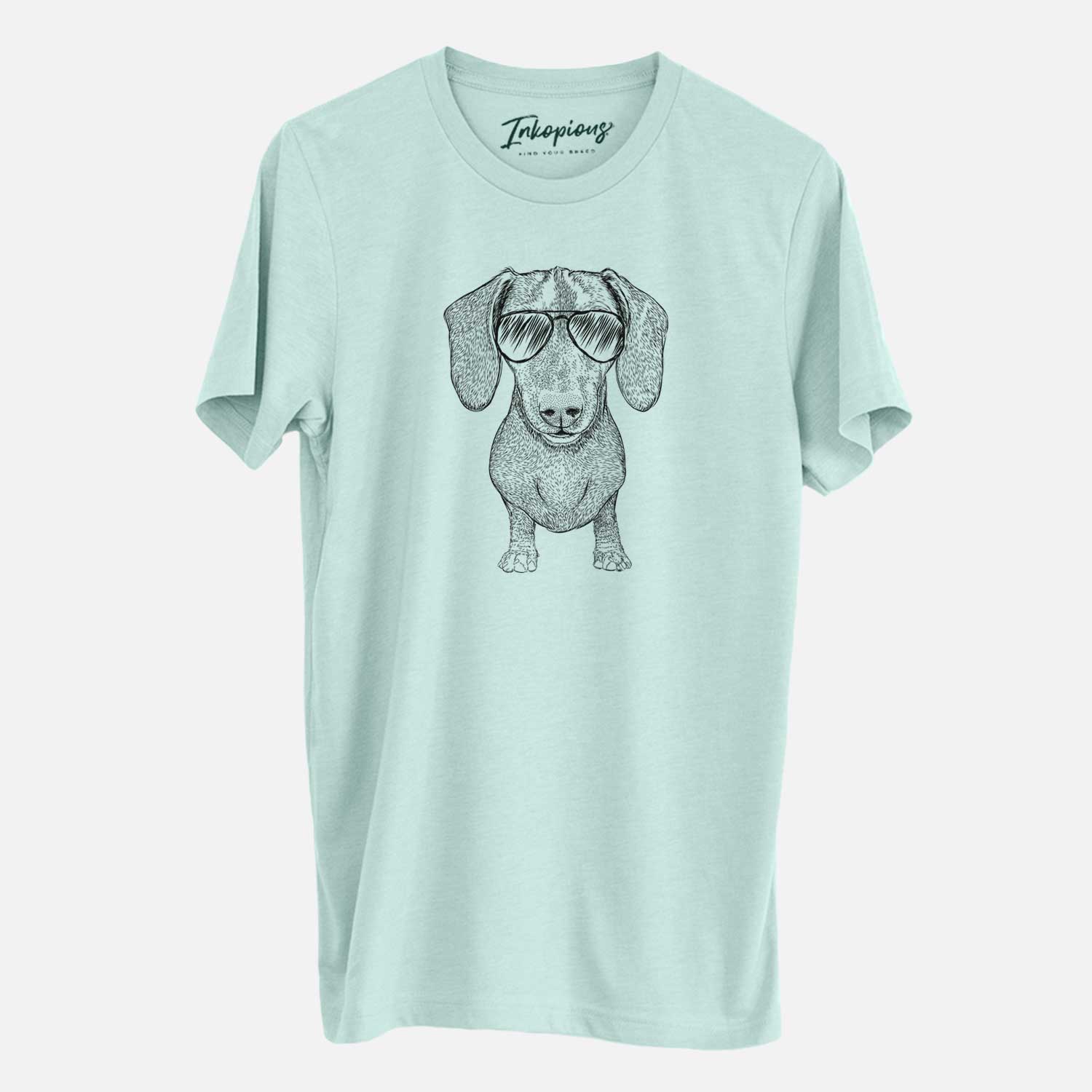 Hand-drawn sketch of Ernie the Mini Dachshund wearing aviator sunglasses on a Heather Sage Unisex crewneck