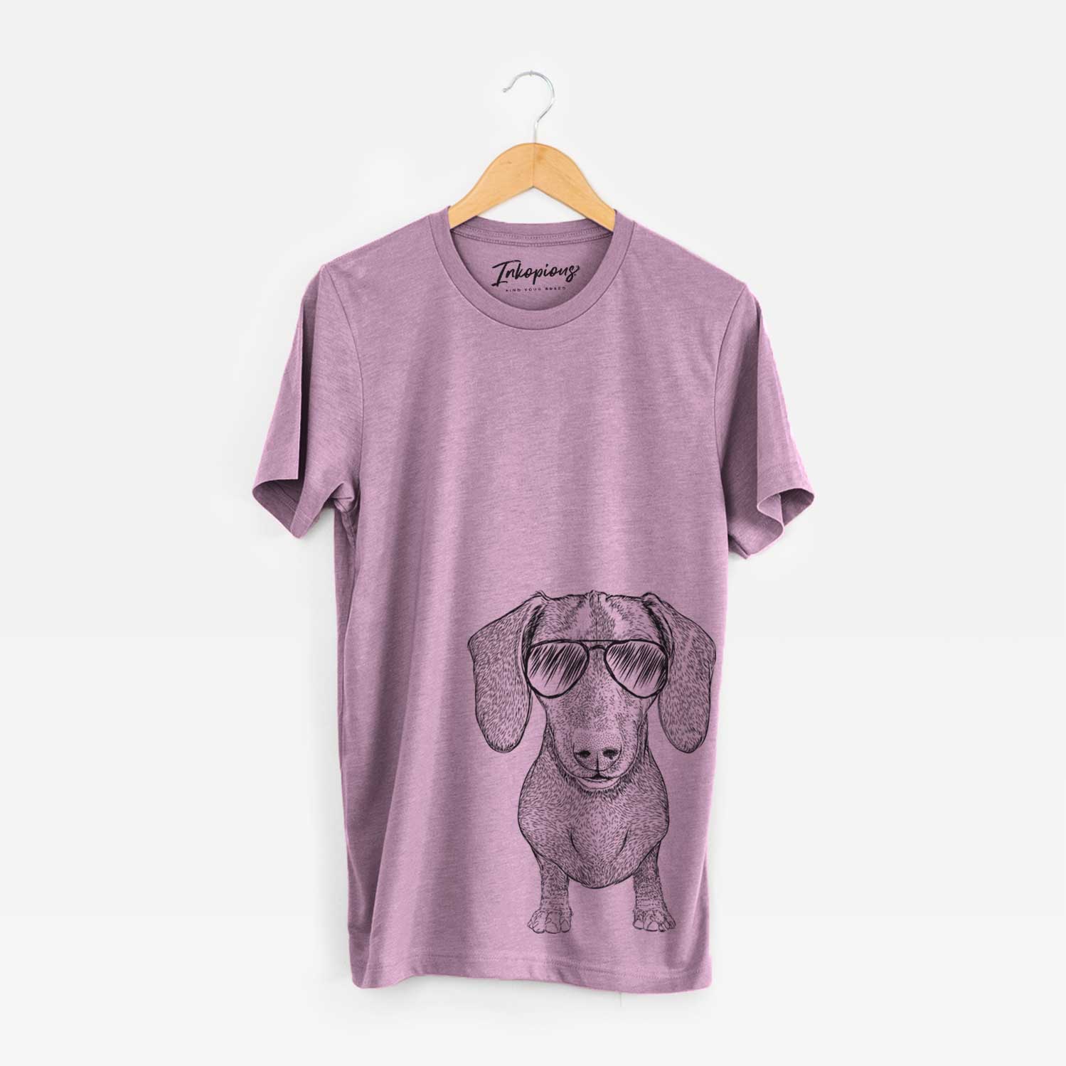 Hand-drawn sketch of Ernie the Mini Dachshund wearing aviator sunglasses on an Orchid Unisex crewneck