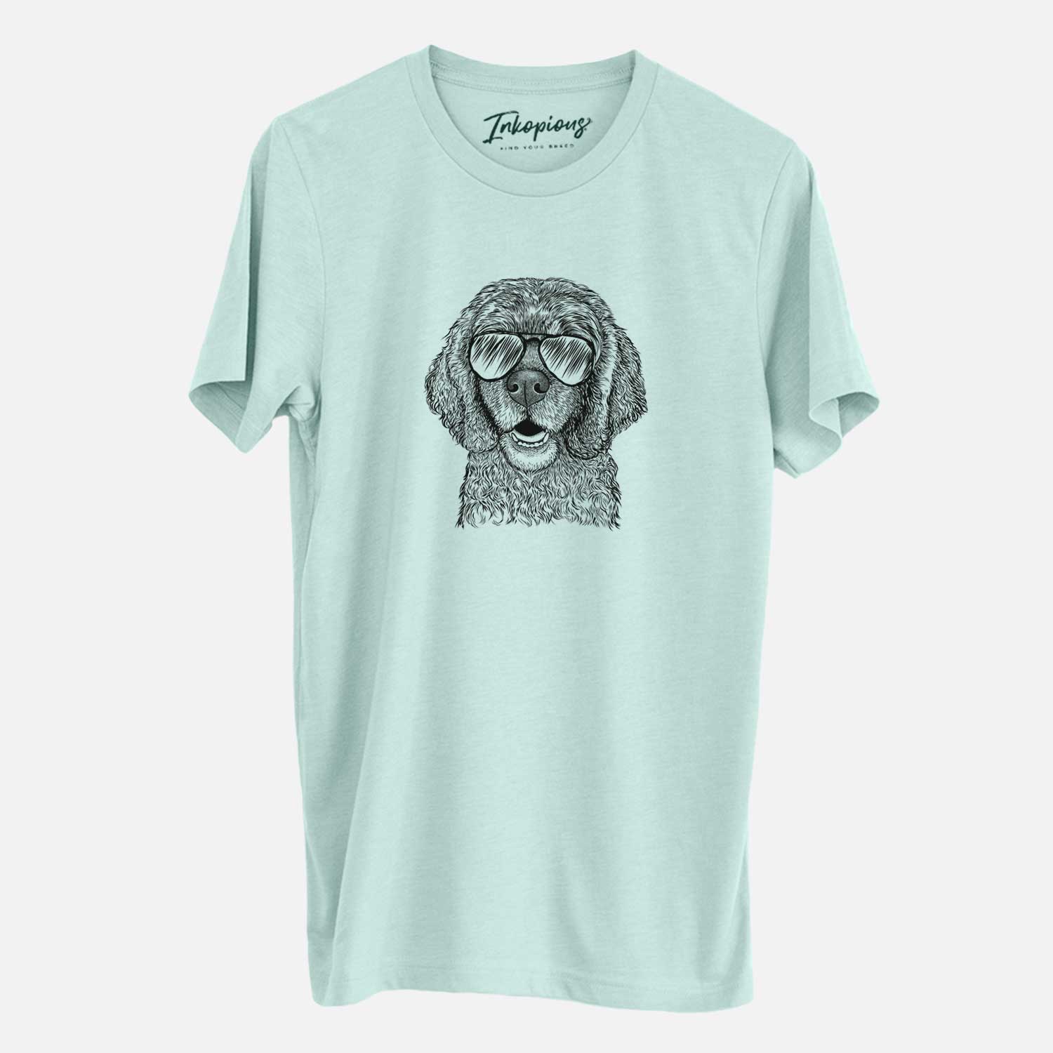 Hand-drawn sketch of Fannie Mae the Cocker Spaniel wearing aviator sunglasses on a Heather Sage Unisex crewneck