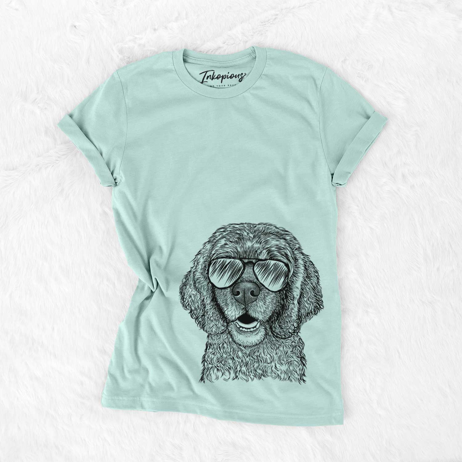 Hand-drawn sketch of Fannie Mae the Cocker Spaniel wearing aviator sunglasses on a Heather Sage Unisex crewneck