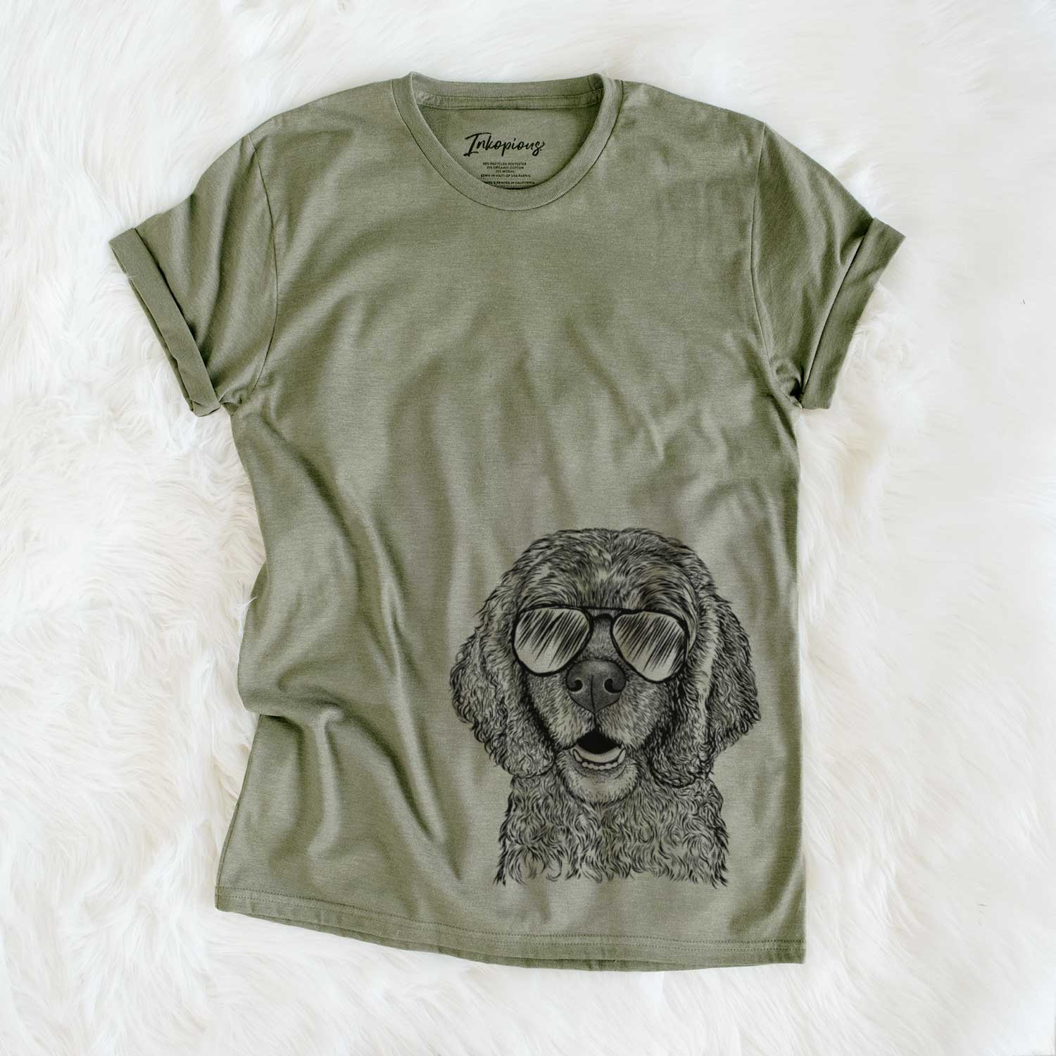 Hand-drawn sketch of Fannie Mae the Cocker Spaniel wearing aviator sunglasses on an Olive Unisex crewneck