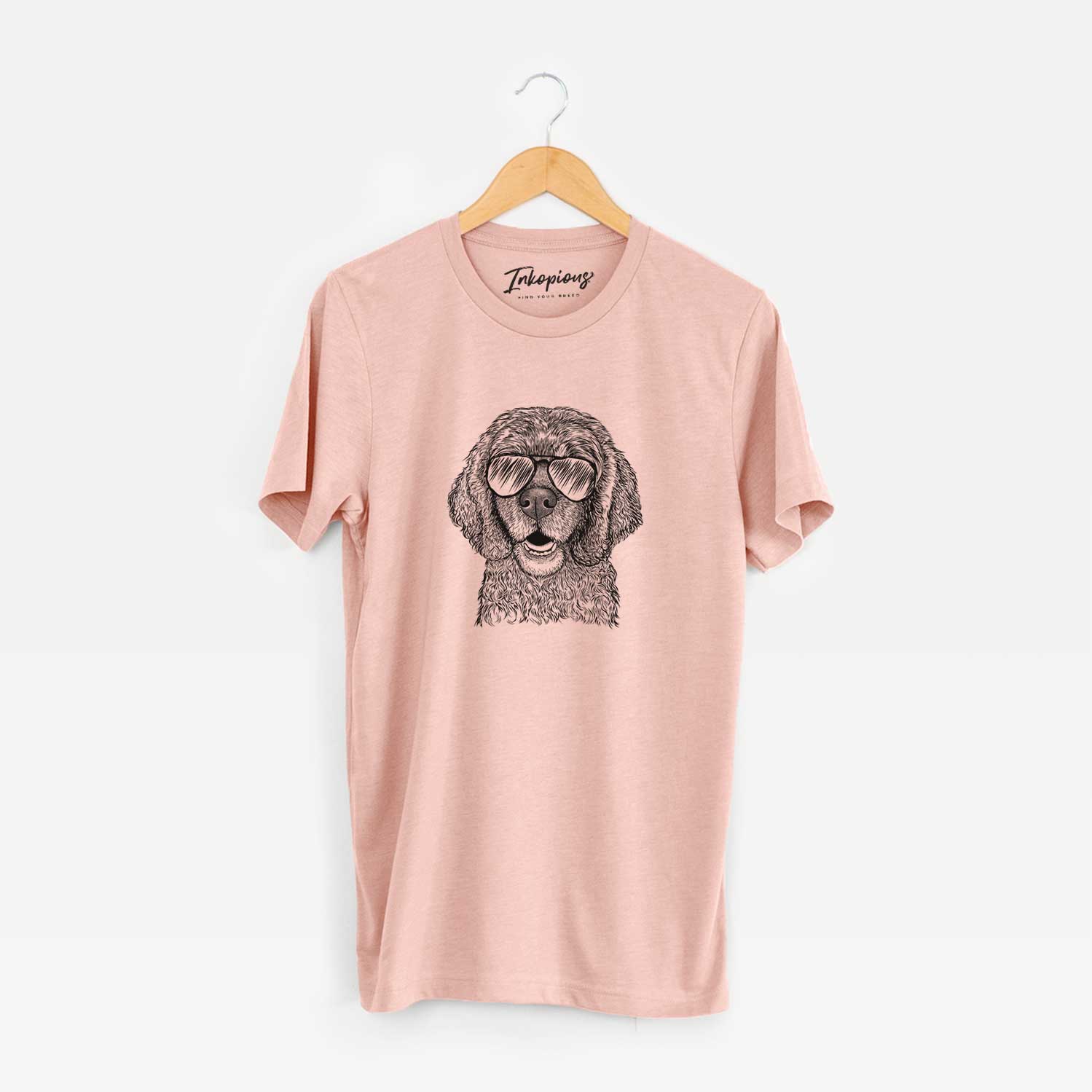 Hand-drawn sketch of Fannie Mae the Cocker Spaniel wearing aviator sunglasses on a Peach Unisex crewneck