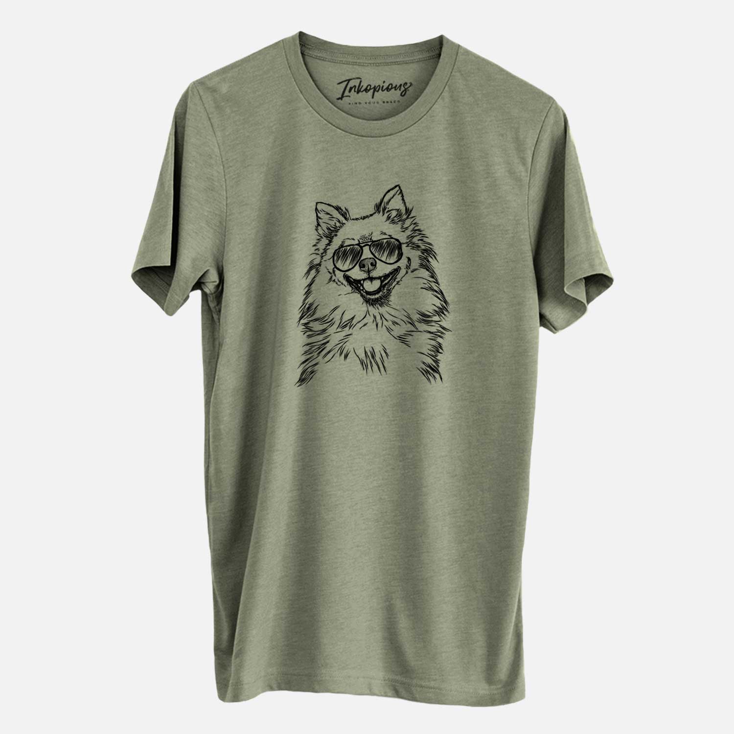 Hand-drawn sketch of Fibi the Spitz wearing aviator sunglasses on an Olive Unisex crewneck