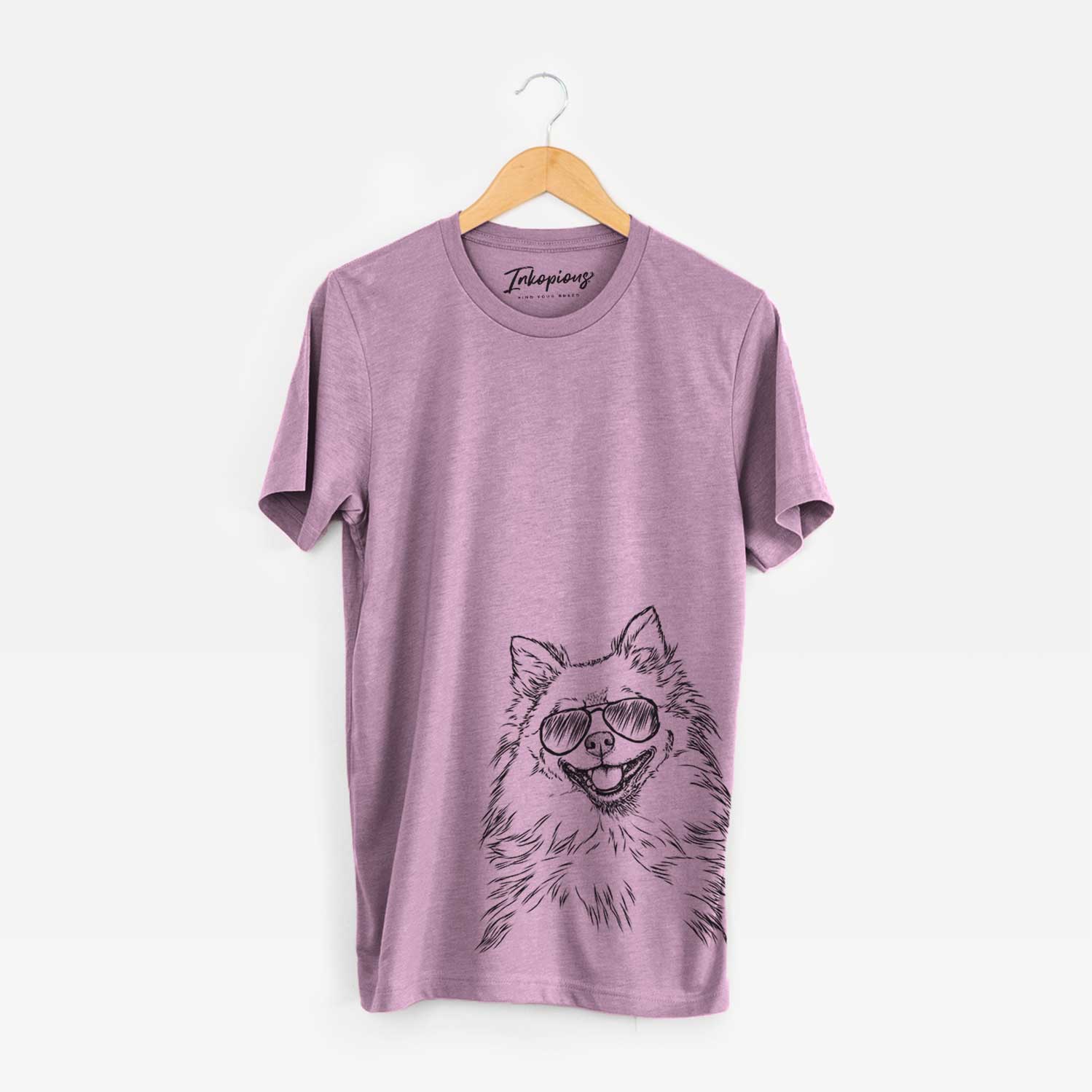 Hand-drawn sketch of Fibi the Spitz wearing aviator sunglasses on an Orchid Bella Canvas Unisex Crewneck