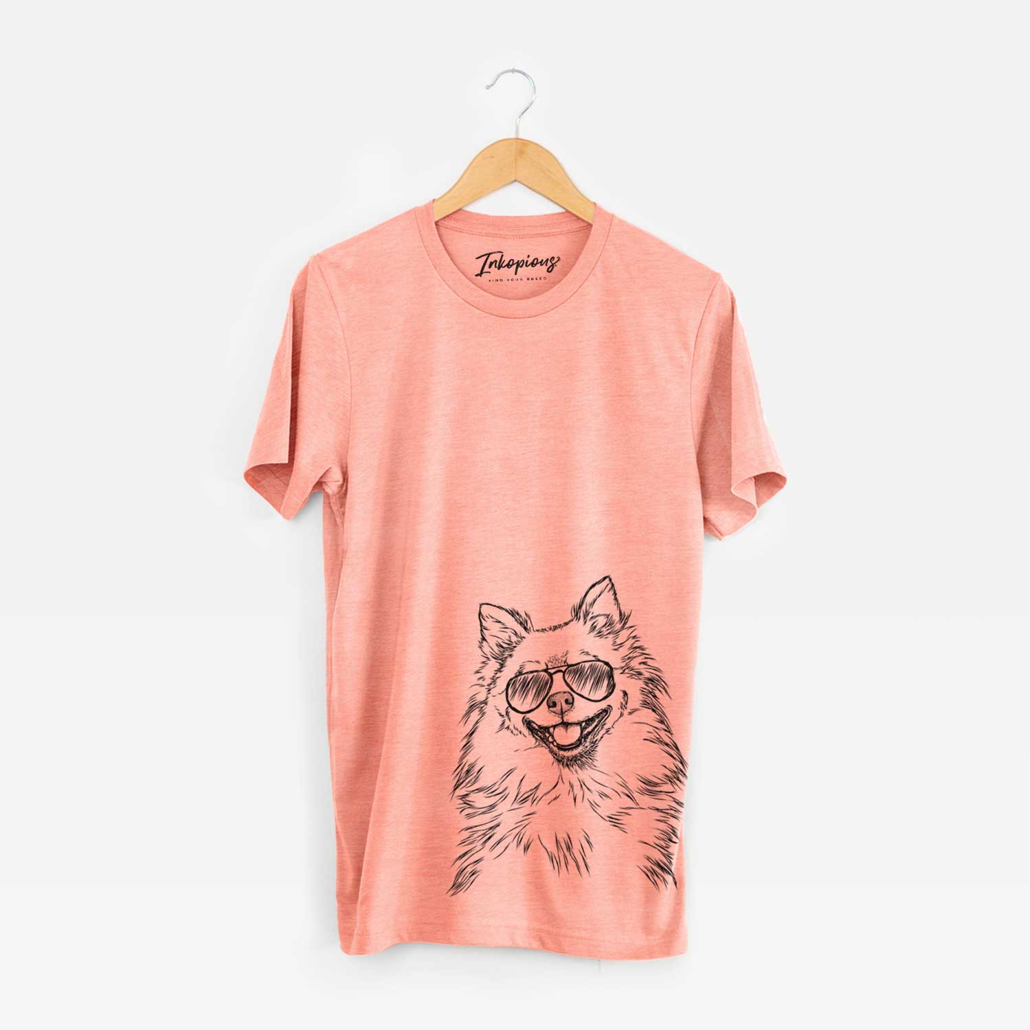 Hand-drawn sketch of Fibi the Spitz wearing aviator sunglasses on a Sunset Unisex crewneck