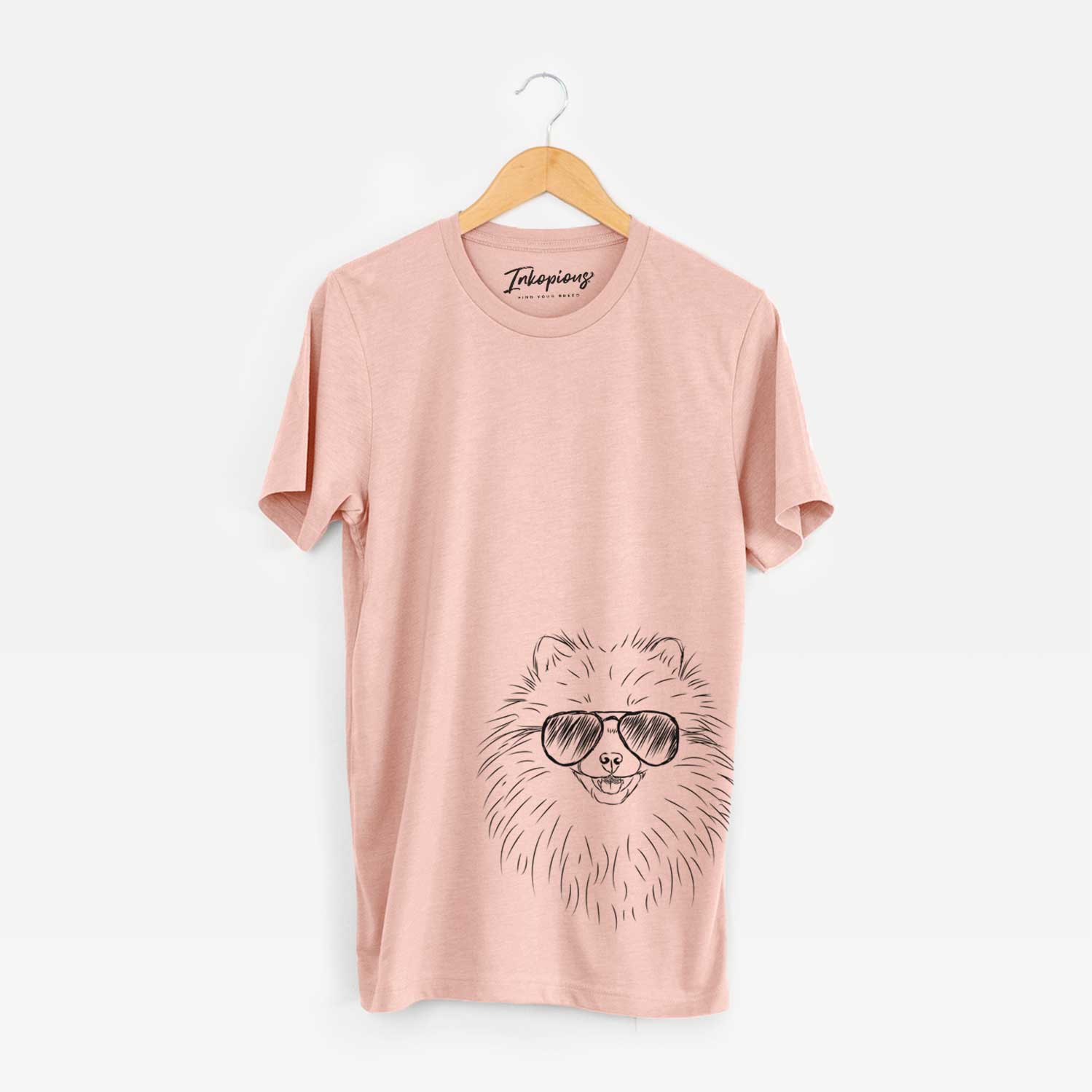 Hand-drawn sketch of Finn the Pomeranian wearing aviator sunglasses on a Peach Bella Canvas Unisex Crewneck