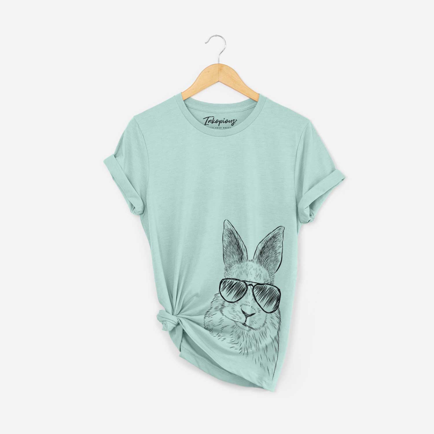 Hand-drawn sketch of Flower the Rex Rabbit wearing aviator sunglasses on a Heather Sage Bella Canvas Unisex Crewneck