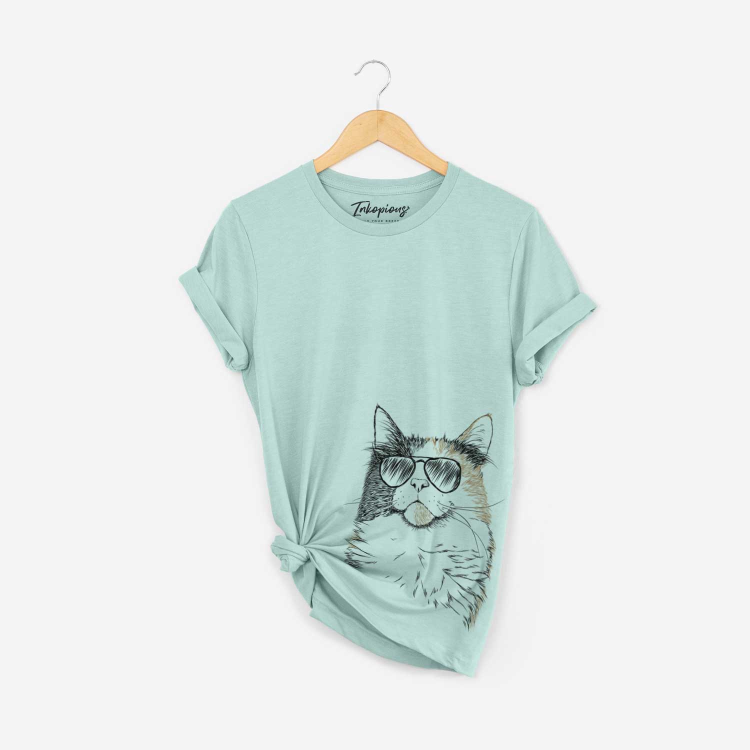 Hand-drawn sketch of Greta the Calico Cat wearing aviator sunglasses on a Heather Sage Bella Canvas Unisex Crewneck