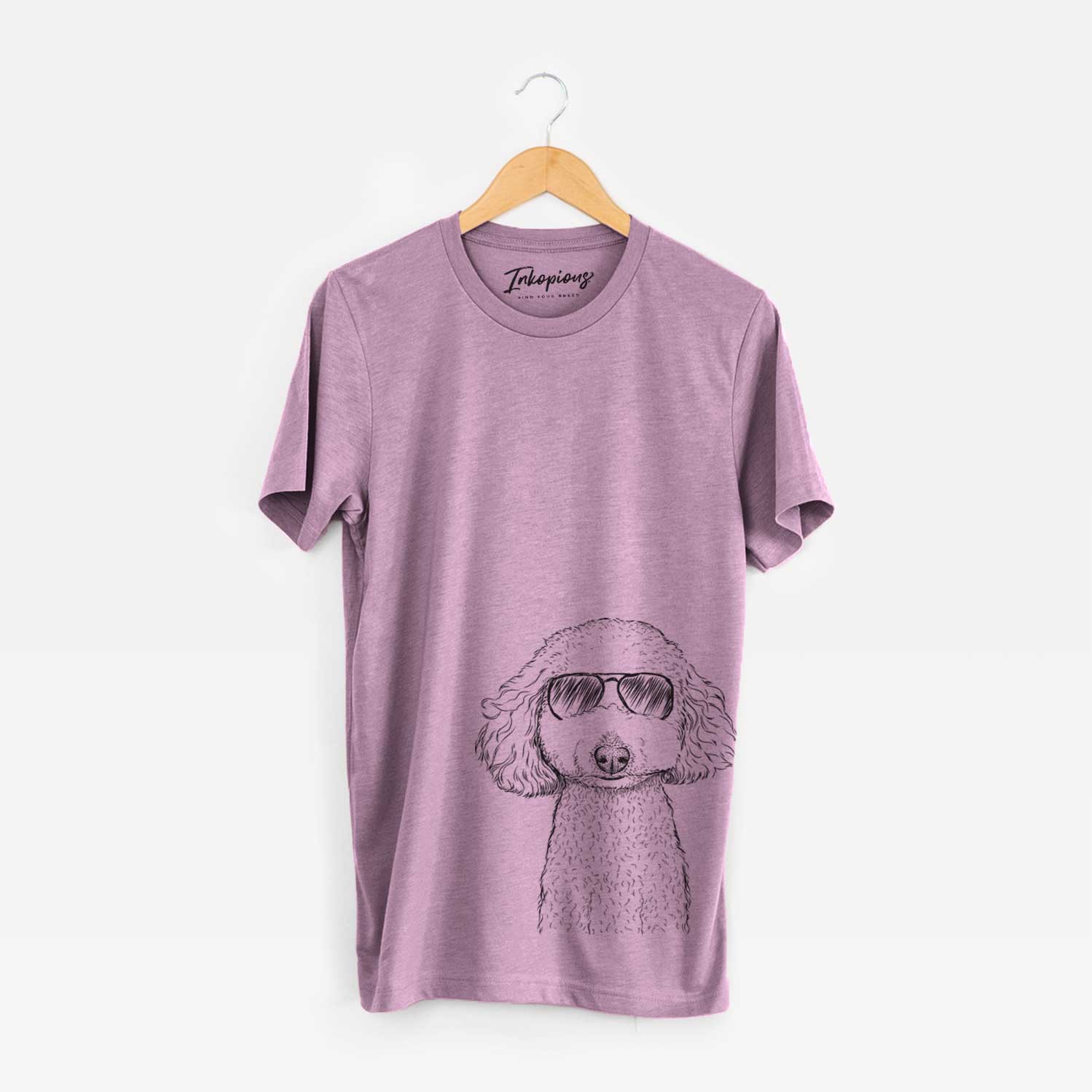 Hand-drawn sketch of Guinness the Toy Poodle Mix wearing aviator sunglasses on an Orchid Unisex crewneck