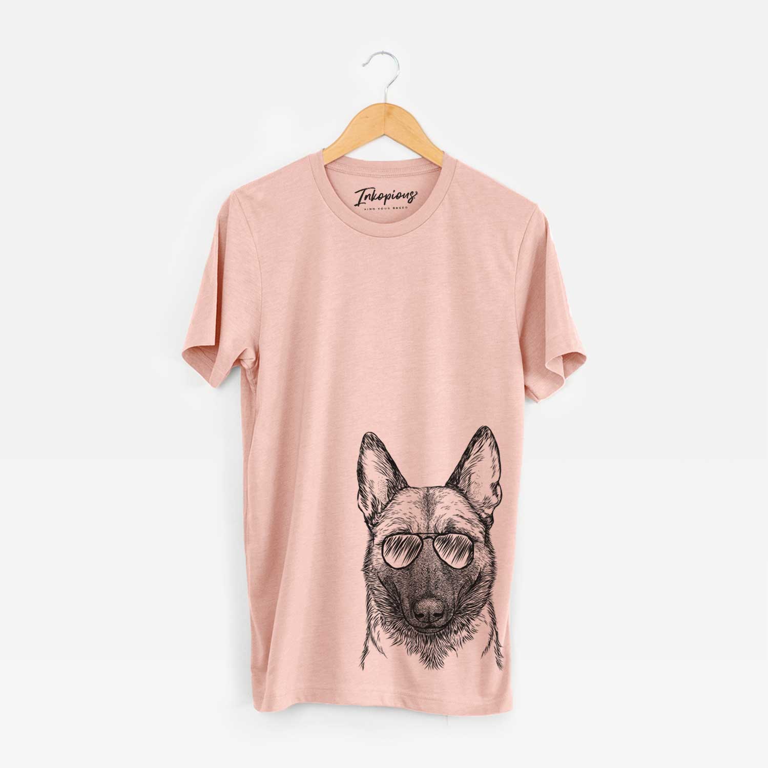 Hand-drawn sketch of Gunther the Belgian Malinois wearing aviator sunglasses on a Peach Bella Canvas Unisex Crewneck