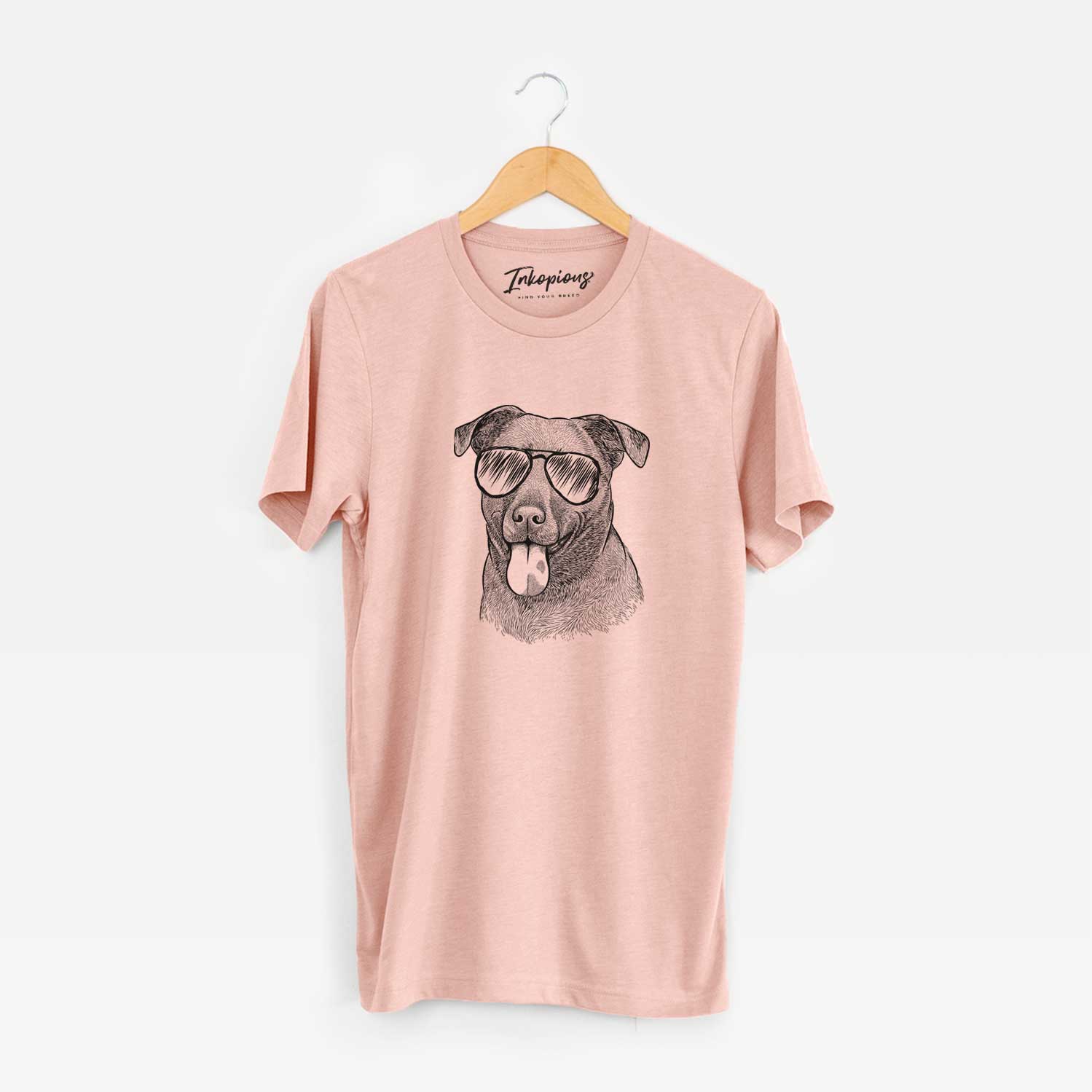 Hand-drawn sketch of Harbor the Mixed Breed wearing aviator sunglasses on a Peach Unisex crewneck