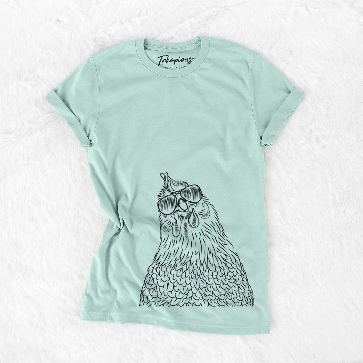 Hand-drawn sketch of Henrietta the Chicken wearing aviator sunglasses on a Heather Sage Unisex crewneck