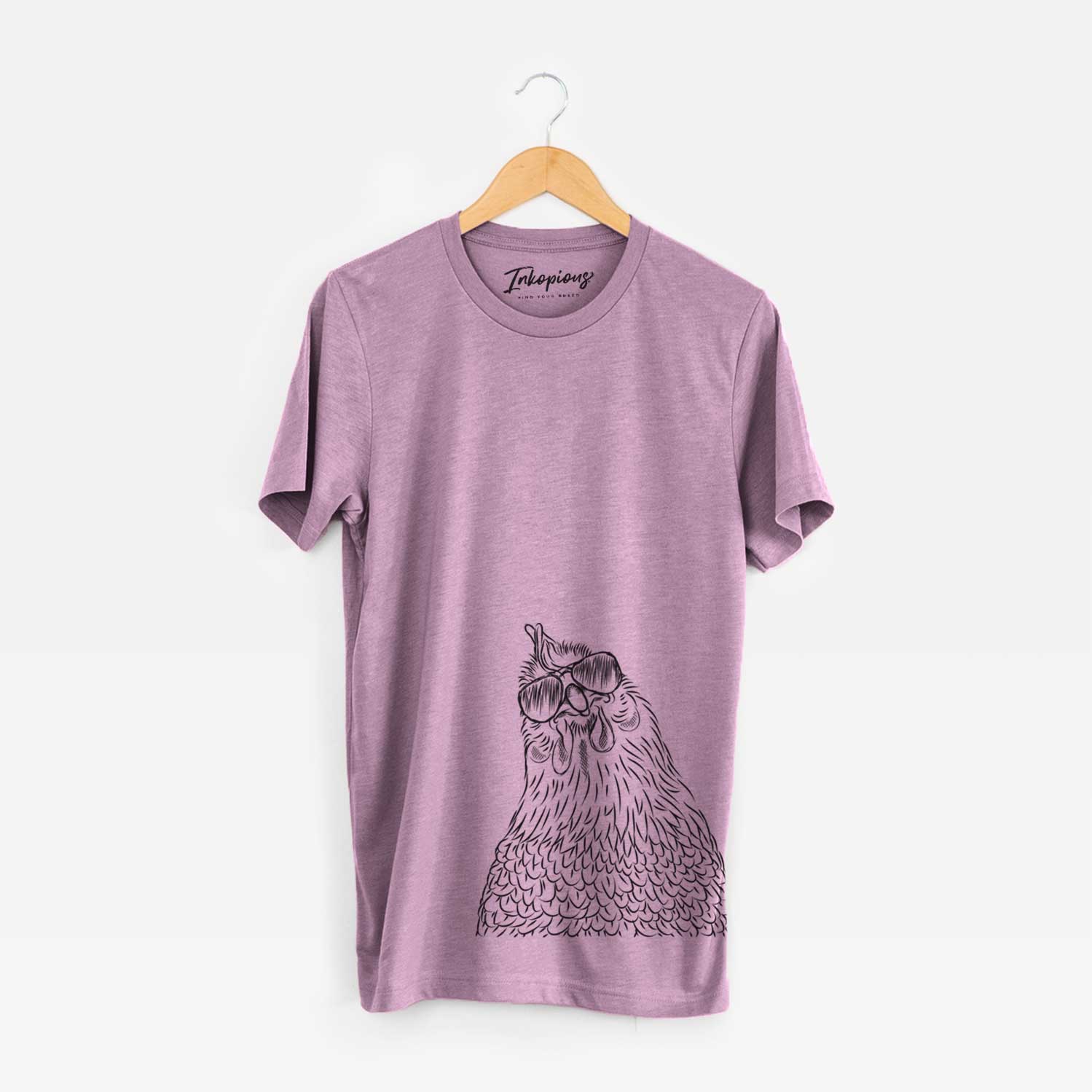 Hand-drawn sketch of Henrietta the Chicken wearing aviator sunglasses on an Orchid Unisex crewneck