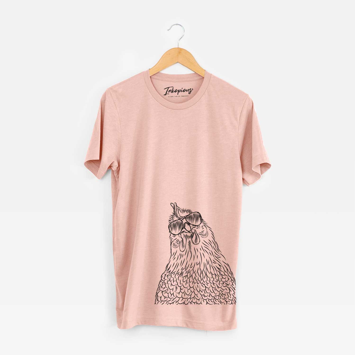 Hand-drawn sketch of Henrietta the Chicken wearing aviator sunglasses on a Peach Unisex crewneck