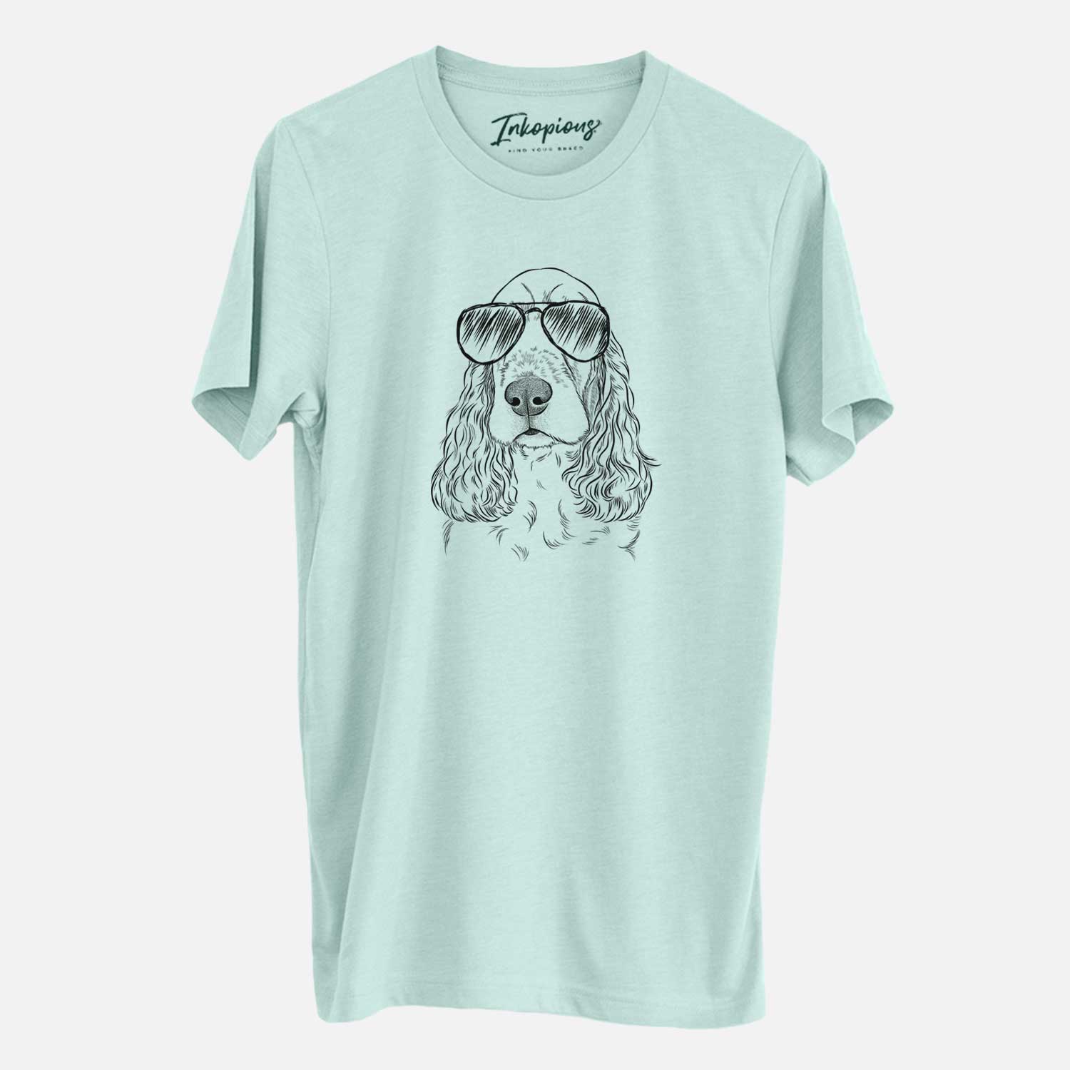 Hand-drawn sketch of Henry the English Cocker Spaniel wearing aviator sunglasses on a Heather Sage Unisex crewneck