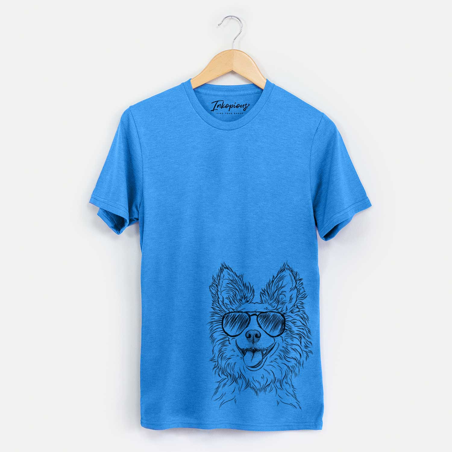 Hand-drawn sketch of Jasper the Pomchi wearing aviator sunglasses on a Blue Unisex crewneck