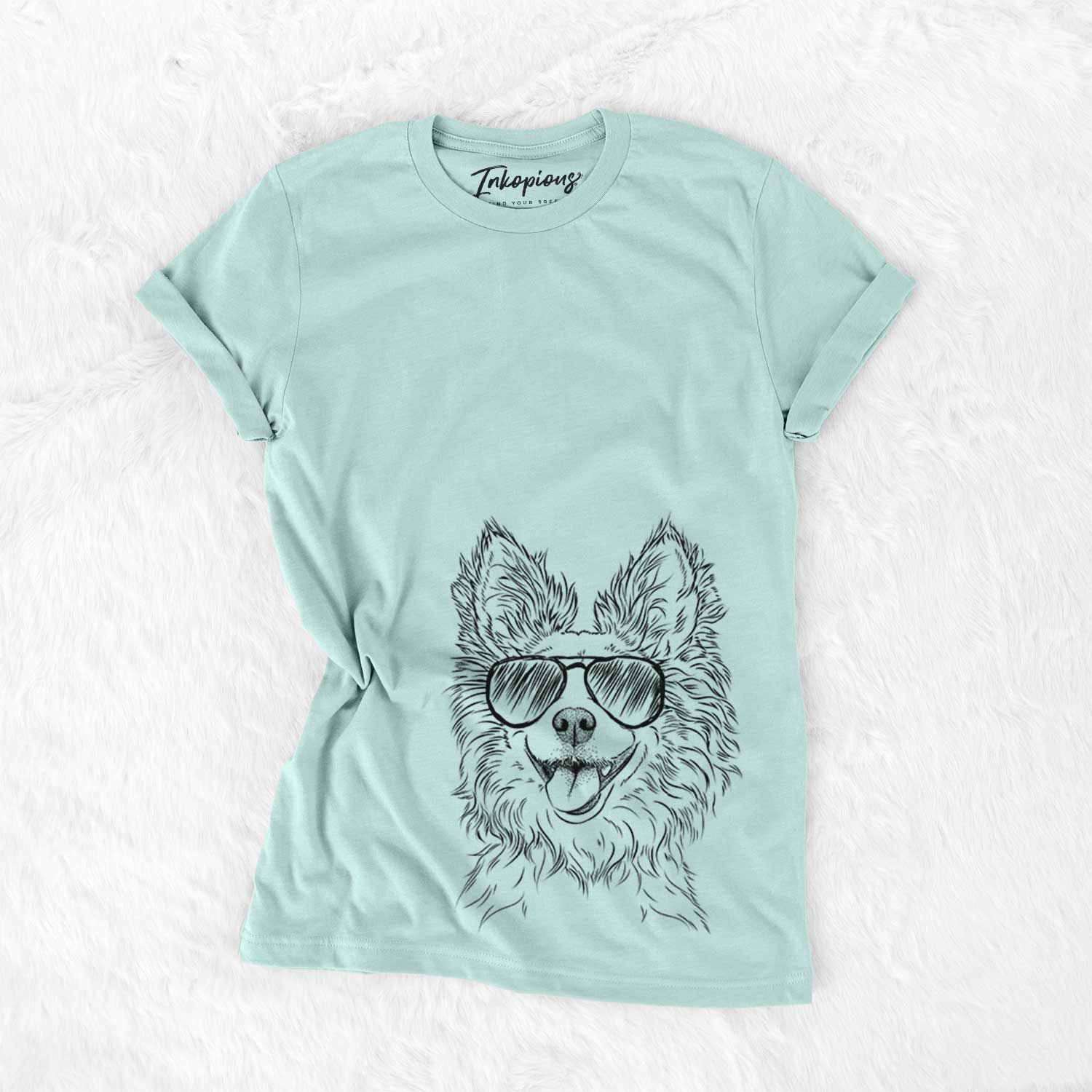 Hand-drawn sketch of Jasper the Pomchi wearing aviator sunglasses on a Heather Sage Unisex crewneck