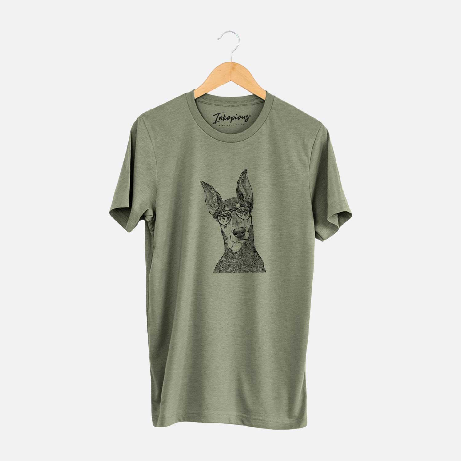 Hand-drawn sketch of Jenna the Doberman Pinscher wearing aviator sunglasses on an Olive Unisex crewneck