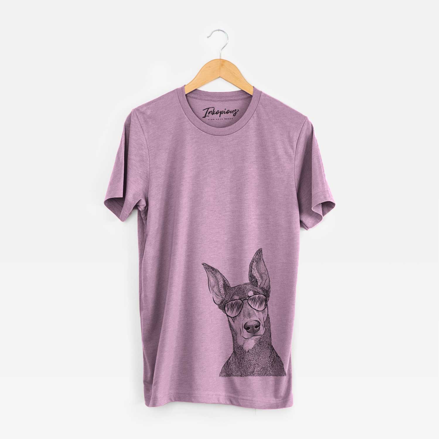 Hand-drawn sketch of Jenna the Doberman Pinscher wearing aviator sunglasses on an Orchid Unisex crewneck