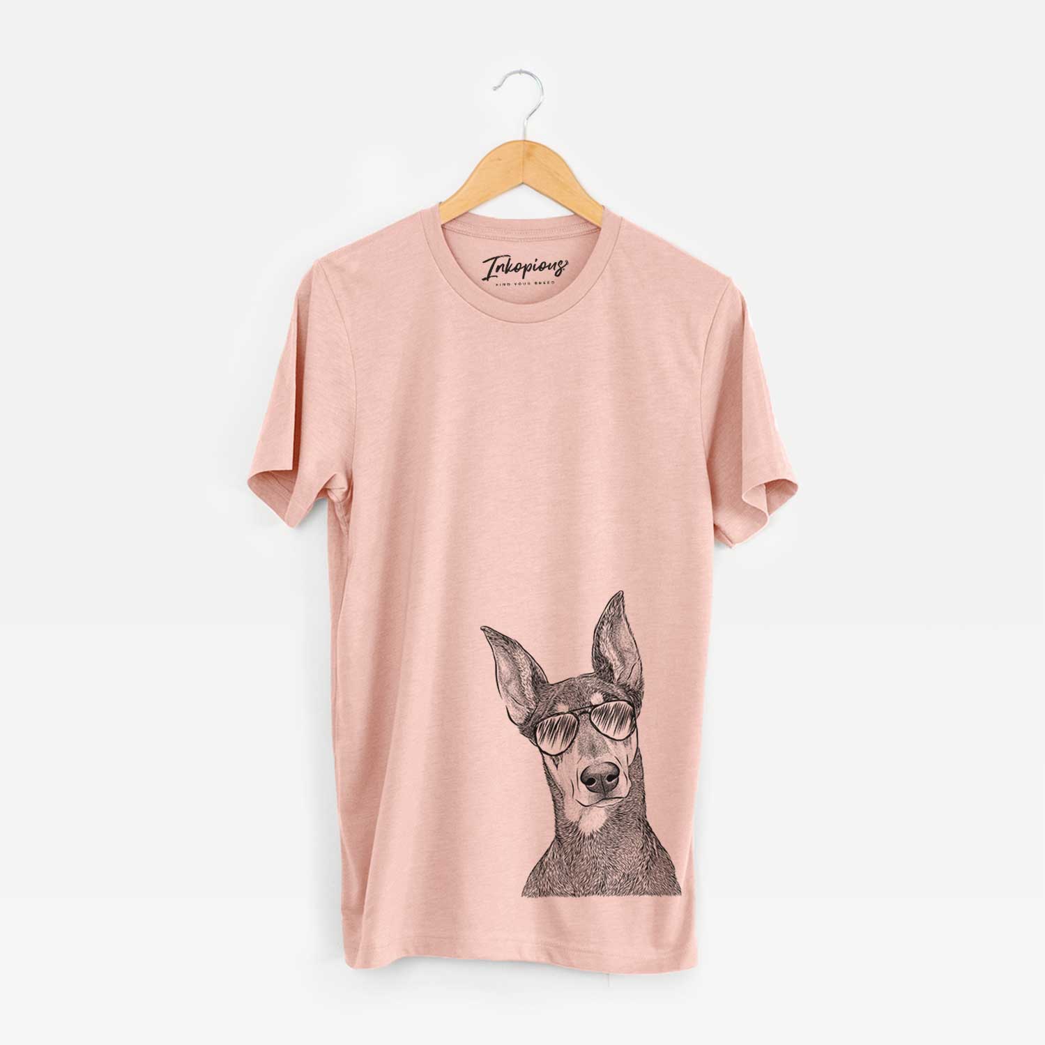 Hand-drawn sketch of Jenna the Doberman Pinscher wearing aviator sunglasses on a Peach Unisex crewneck