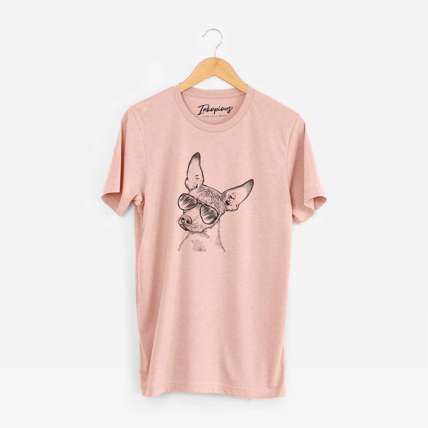 Hand-drawn sketch of Kahlo the Xoloitzcuintli wearing aviator sunglasses on a Peach Unisex crewneck