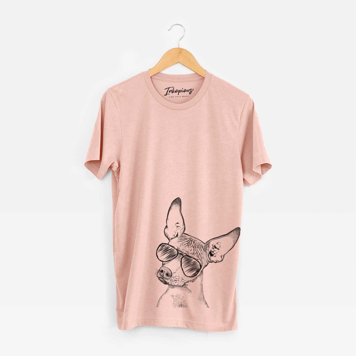 Hand-drawn sketch of Kahlo the Xoloitzcuintli wearing aviator sunglasses on a Peach Unisex crewneck