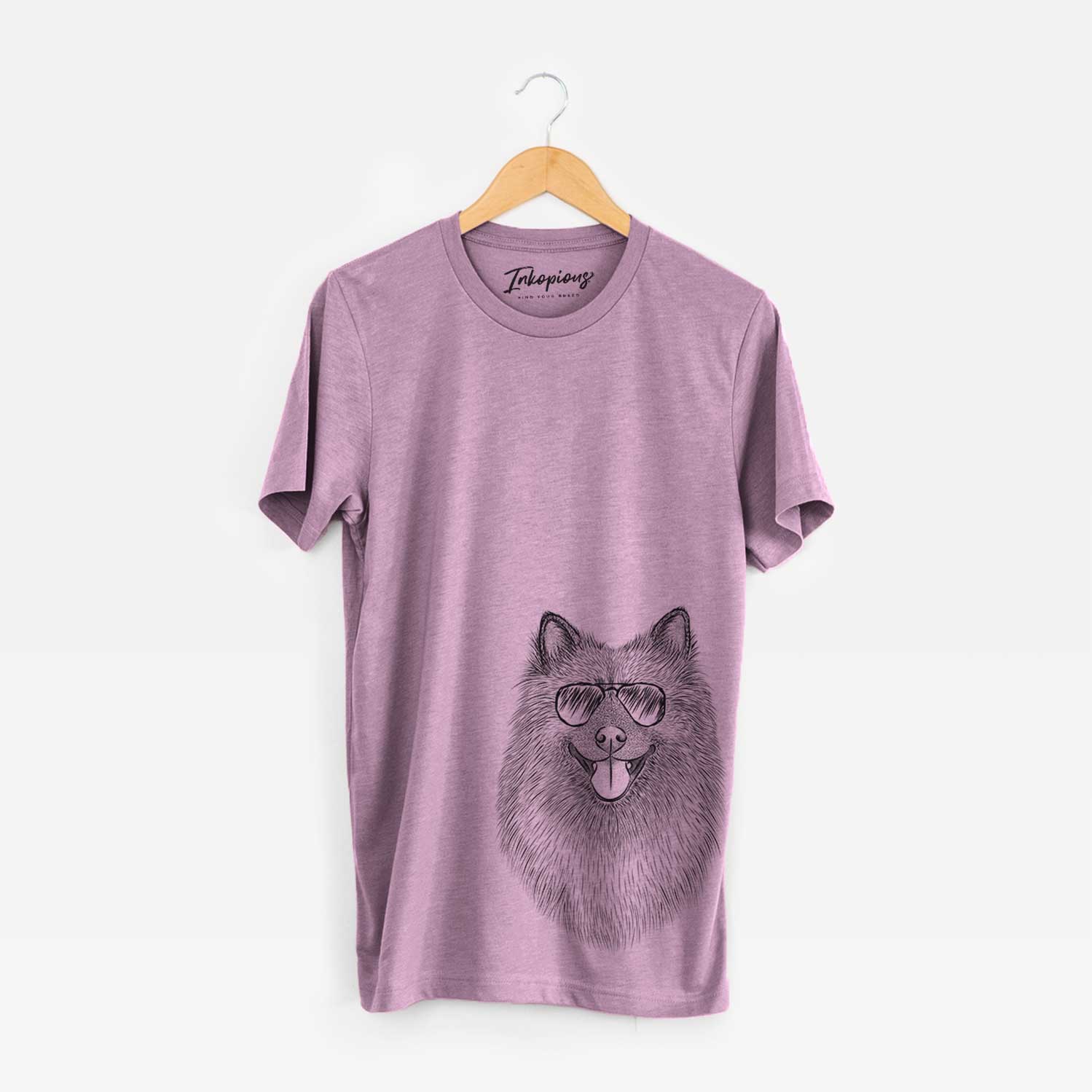 Hand-drawn sketch of Kai the Keeshond wearing aviator sunglasses on an Orchid Bella Canvas Unisex Crewneck