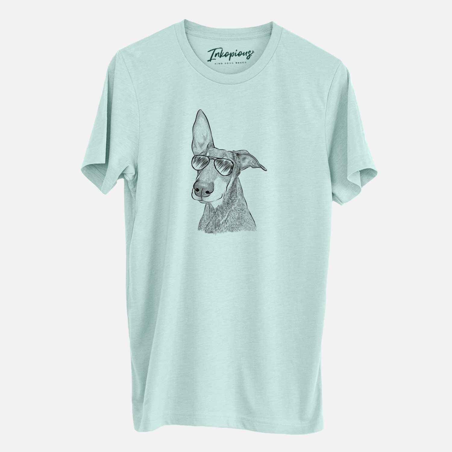 Hand-drawn sketch of Kain the Doberman Pinscher wearing aviator sunglasses on a Heather Sage Unisex crewneck