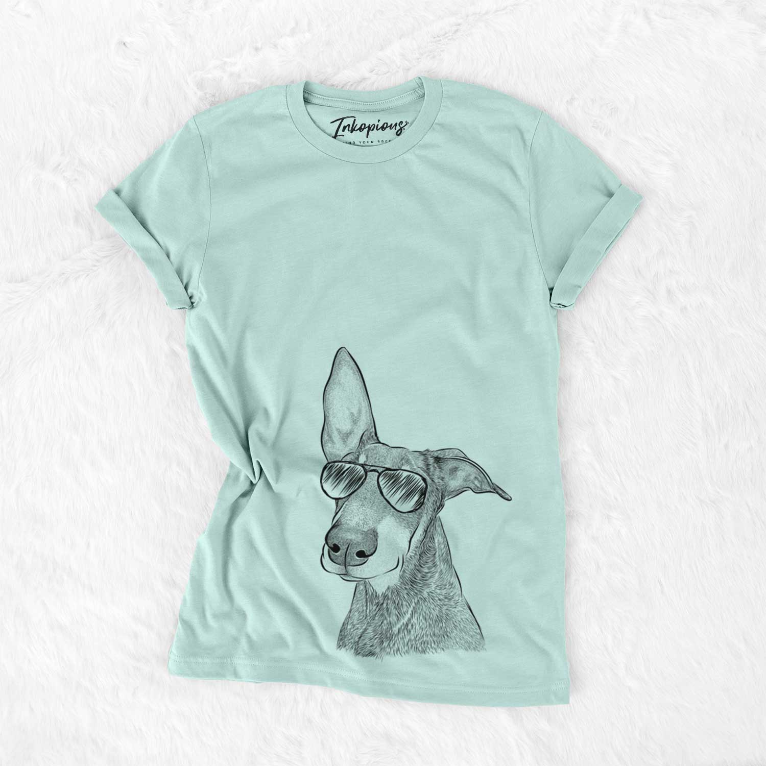 Hand-drawn sketch of Kain the Doberman Pinscher wearing aviator sunglasses on a Heather Sage Unisex crewneck