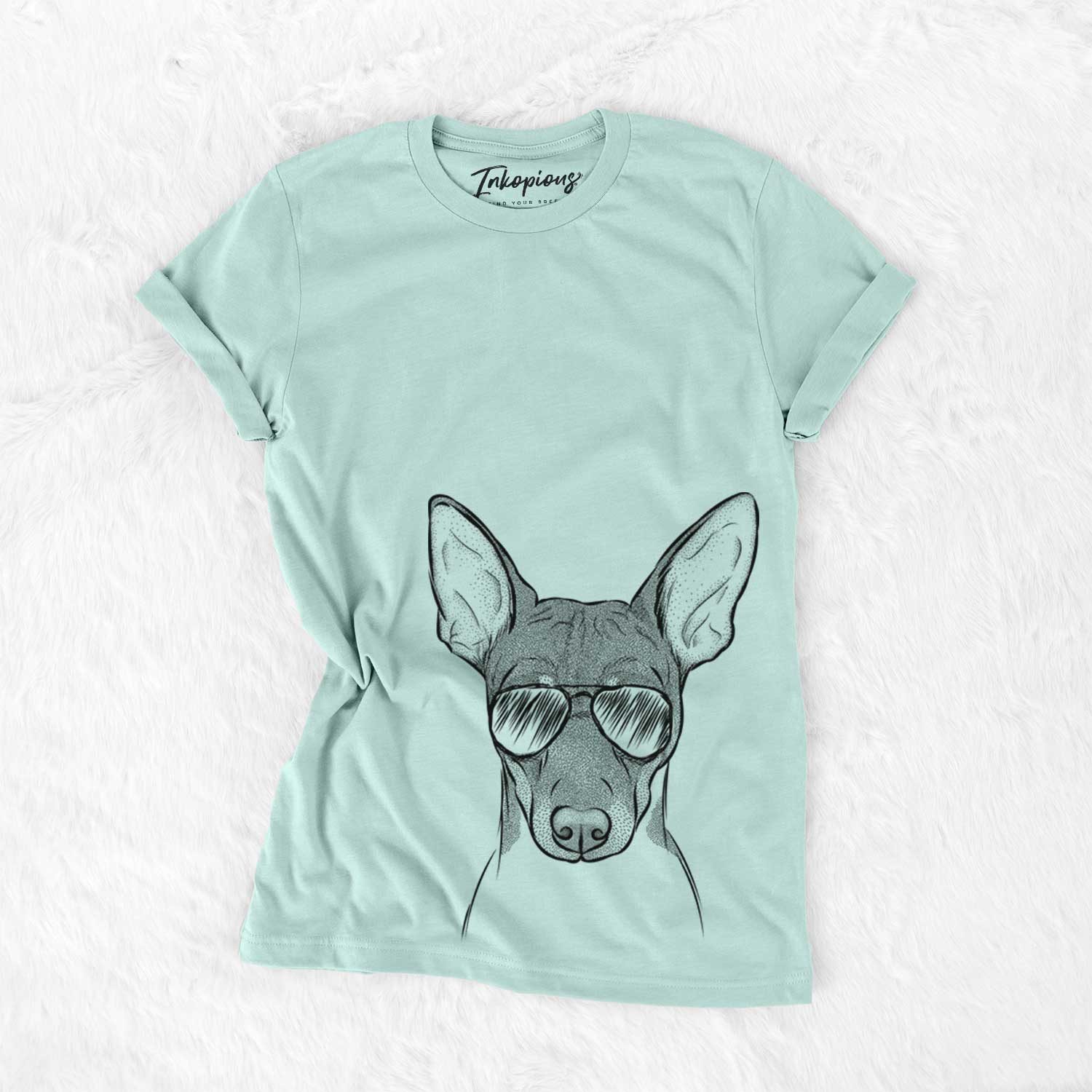 Hand-drawn sketch of Knox the Rat Terrier wearing aviator sunglasses on a Heather Sage Unisex crewneck