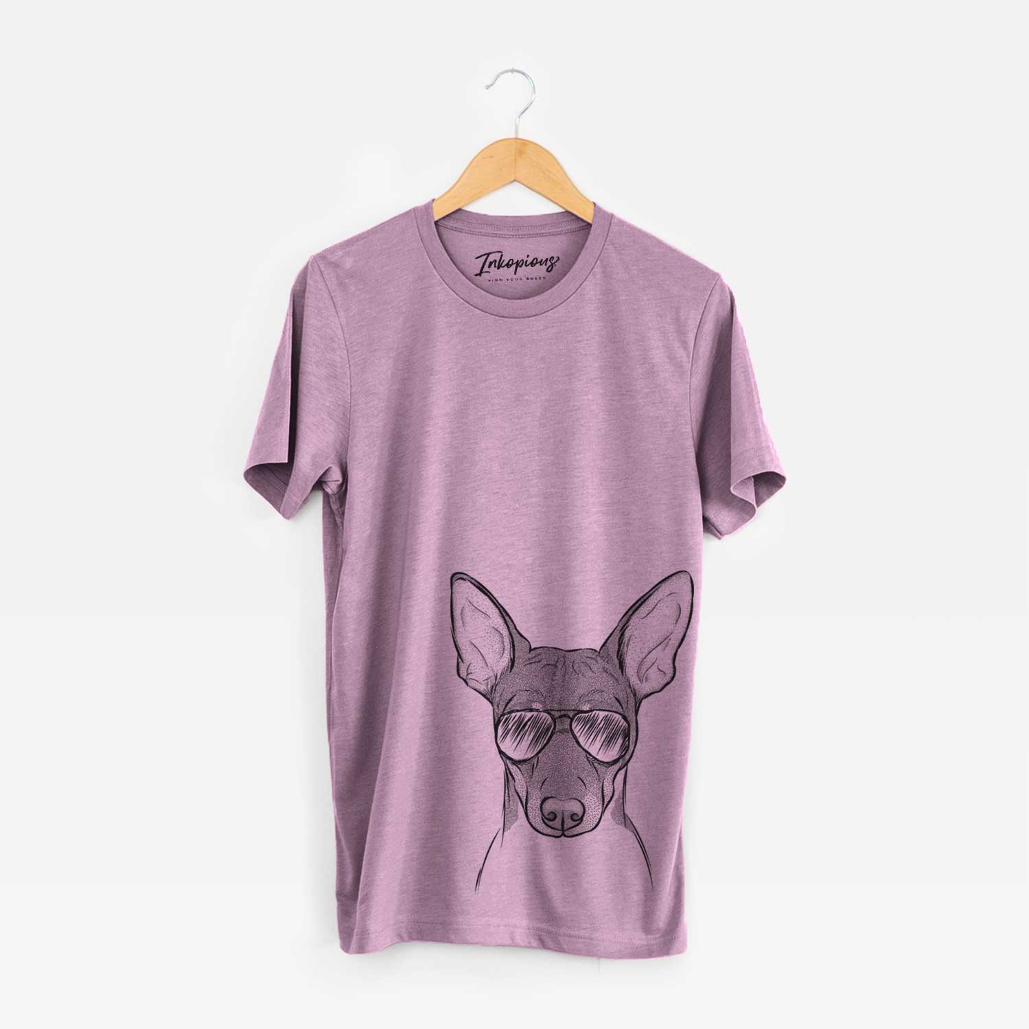 Hand-drawn sketch of Knox the Rat Terrier wearing aviator sunglasses on an Orchid Unisex crewneck